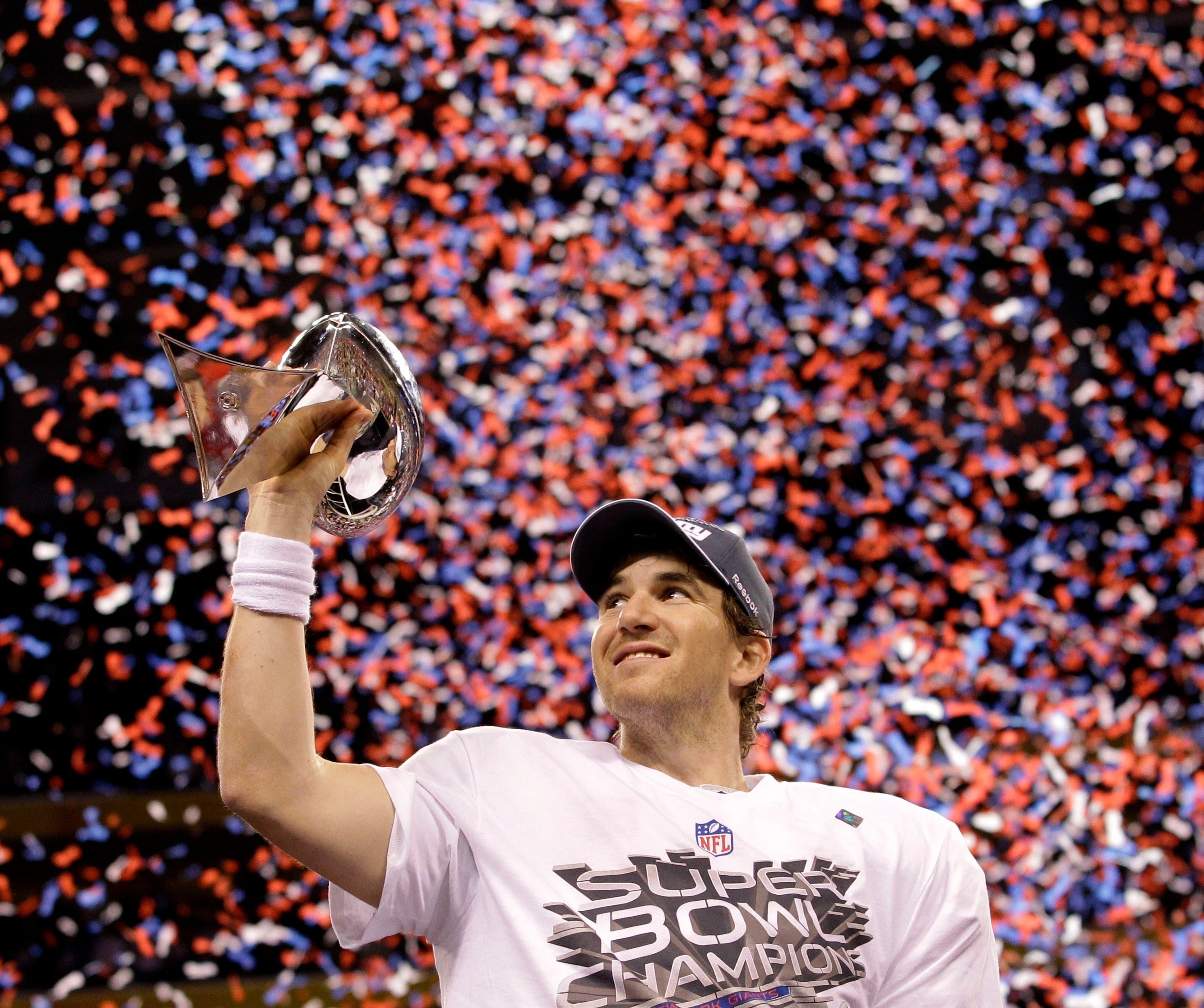 New York Giants quarterback Eli Manning holds up the Vince Lombardi Trophy while celebrating his team's 21-17 win over New England Patriots in the NFL Super Bowl XLVI football game Sunday, Feb. 5, 2012, in Indianapolis.  (AP Photo/David J. Phillip) / David J. Phillip