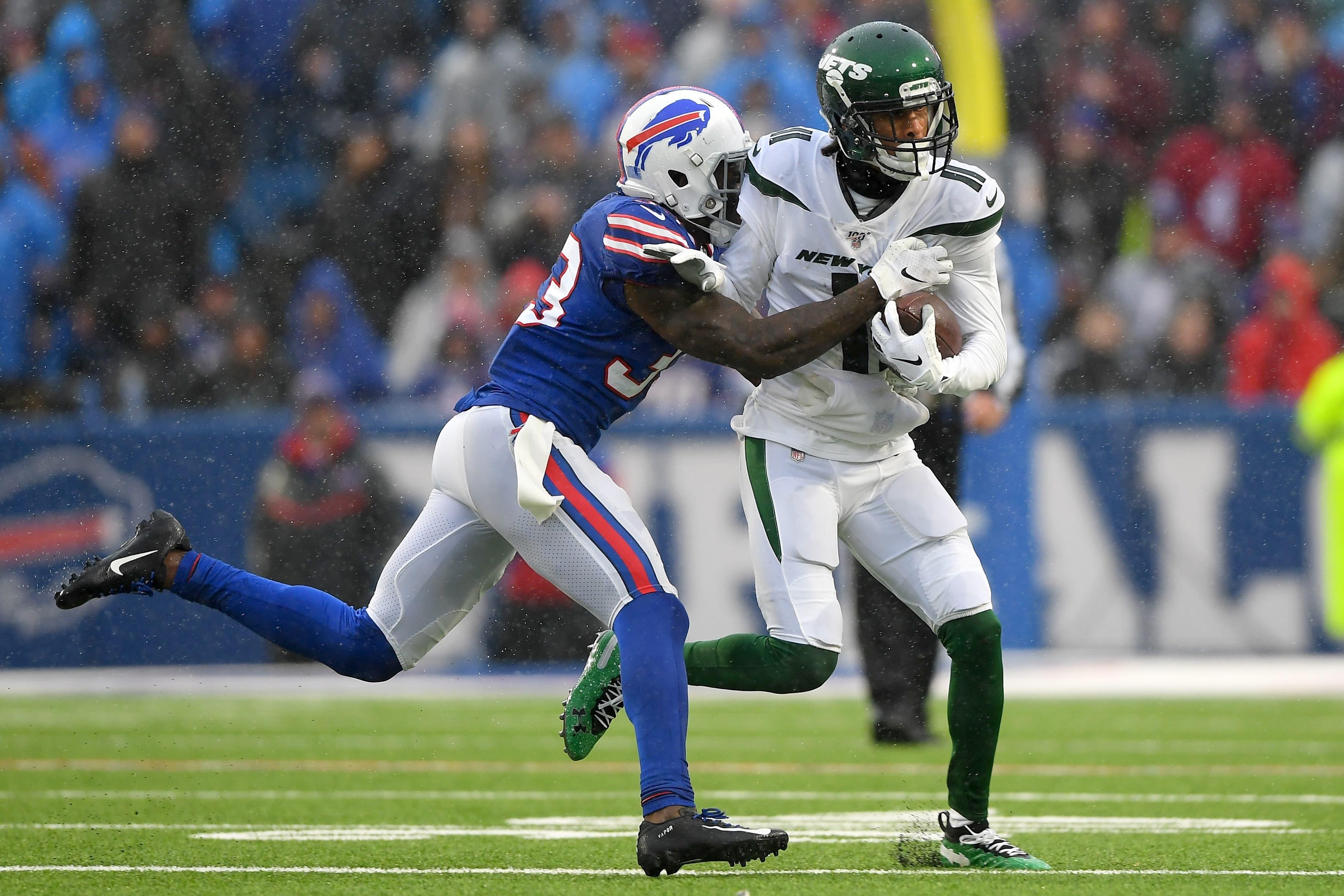 Dec 29, 2019; Orchard Park, New York, USA; New York Jets wide receiver Robby Anderson (11) runs with the ball after a catch as Buffalo Bills defensive back Siran Neal (33) defends during the second quarter at New Era Field. Mandatory Credit: Rich Barnes-USA TODAY Sports / Rich Barnes