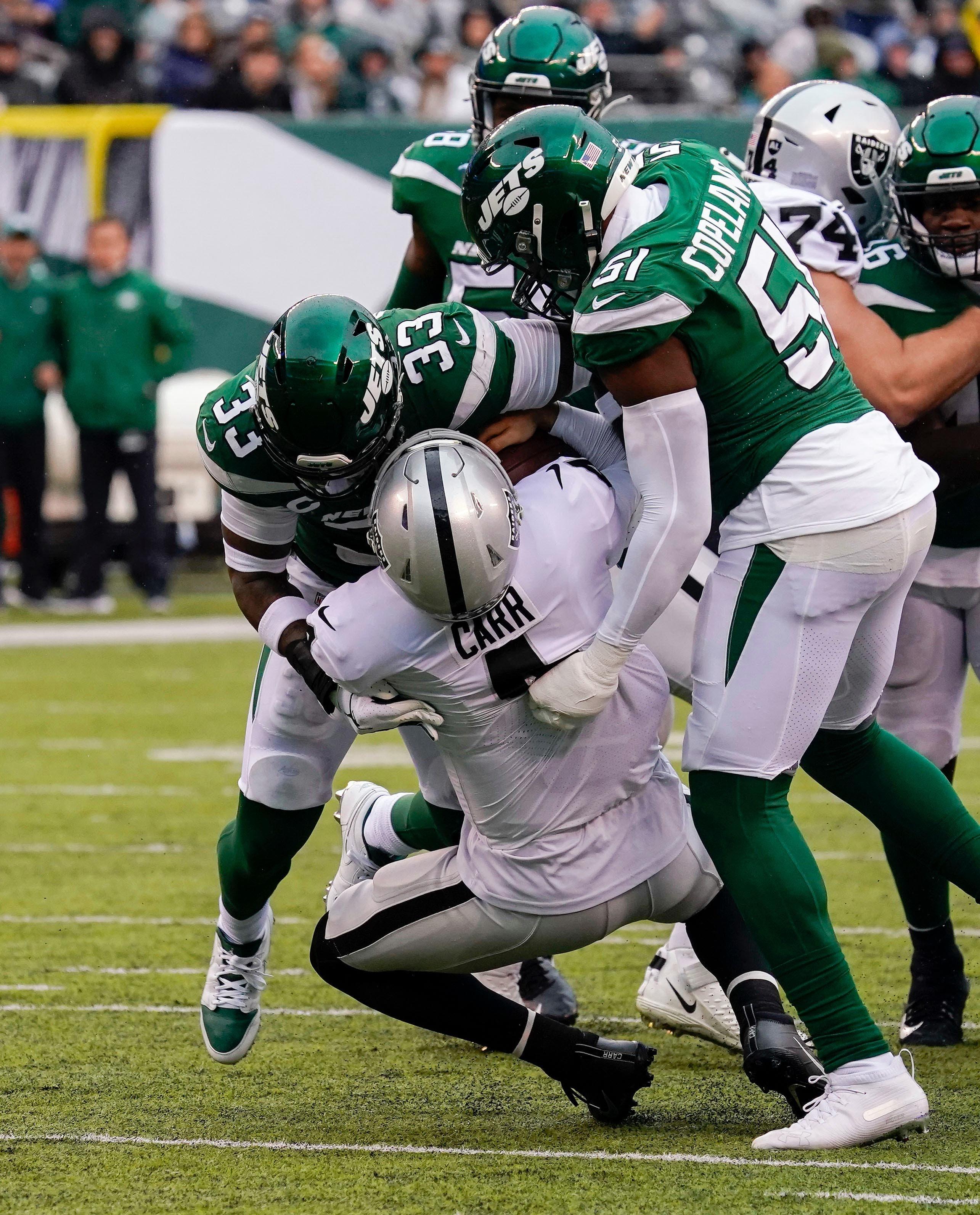 Nov 24, 2019; East Rutherford, NJ, USA; Oakland Raiders quarterback Derek Carr (4) is sacked by New York Jets strong safety Jamal Adams (33) and New York Jets outside linebacker Brandon Copeland (51) during the first half at MetLife Stadium. Mandatory Credit: Robert Deutsch-USA TODAY Sports / Robert Deutsch