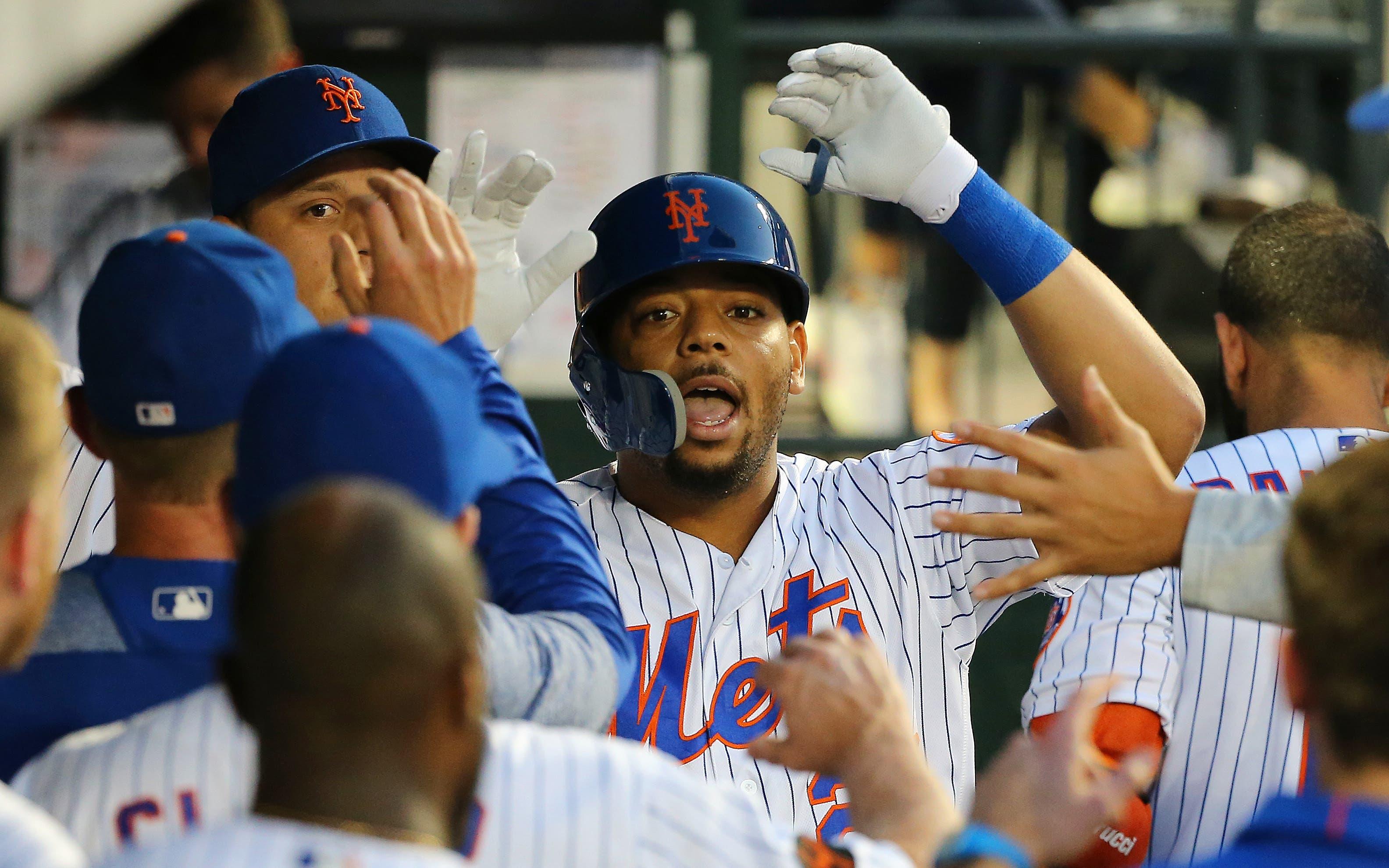 Aug 22, 2018; New York City, NY, USA; New York Mets first baseman Dominic Smith (22) is congratulated after hitting a solo home run against the San Francisco Giants during the second inning at Citi Field. Mandatory Credit: Andy Marlin-USA TODAY Sports / Andy Marlin