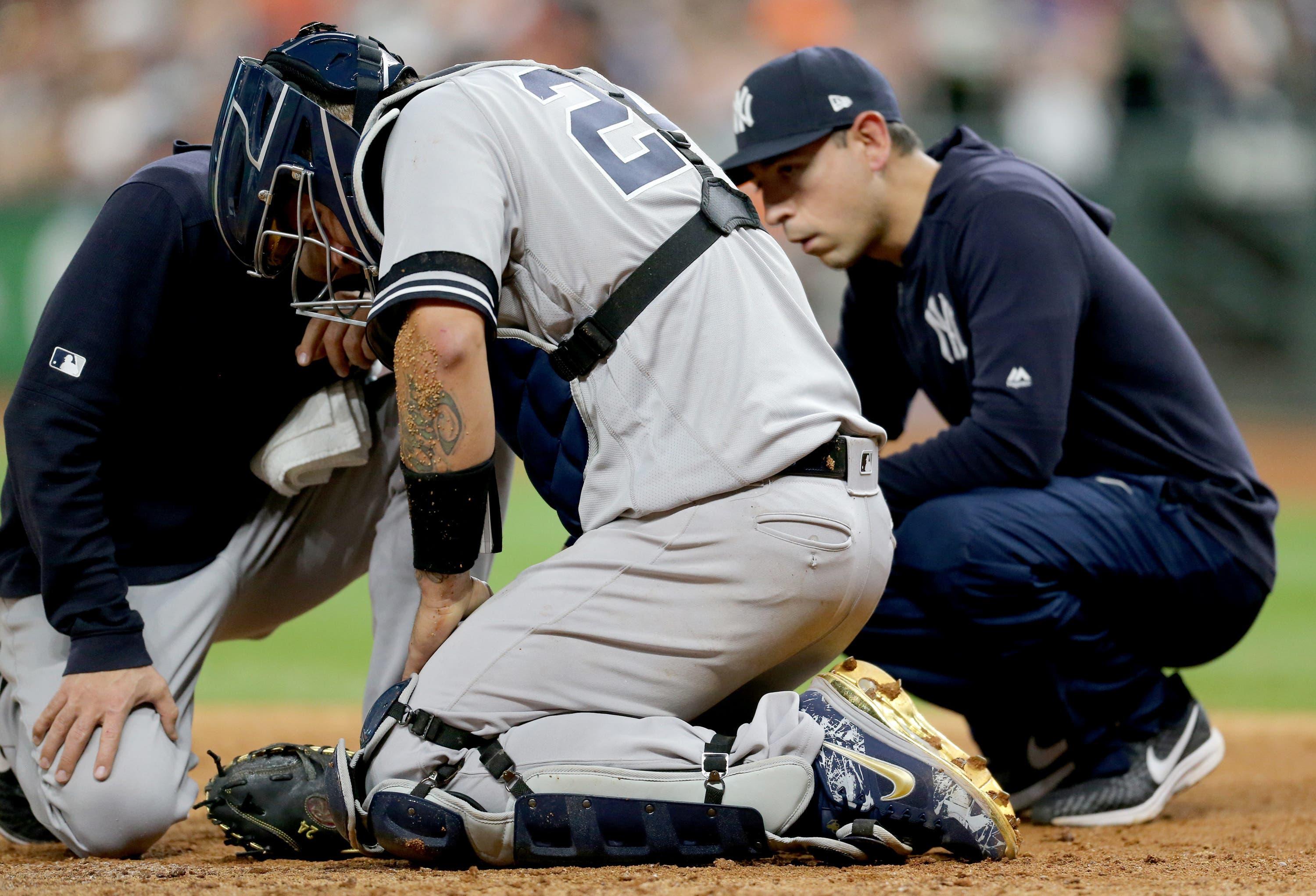 Trainers examine New York Yankees catcher Gary Sanchez after he was injured playing against the Houston Astros in the seventh inning at Minute Maid Park. / Thomas Shea/USA TODAY Sports