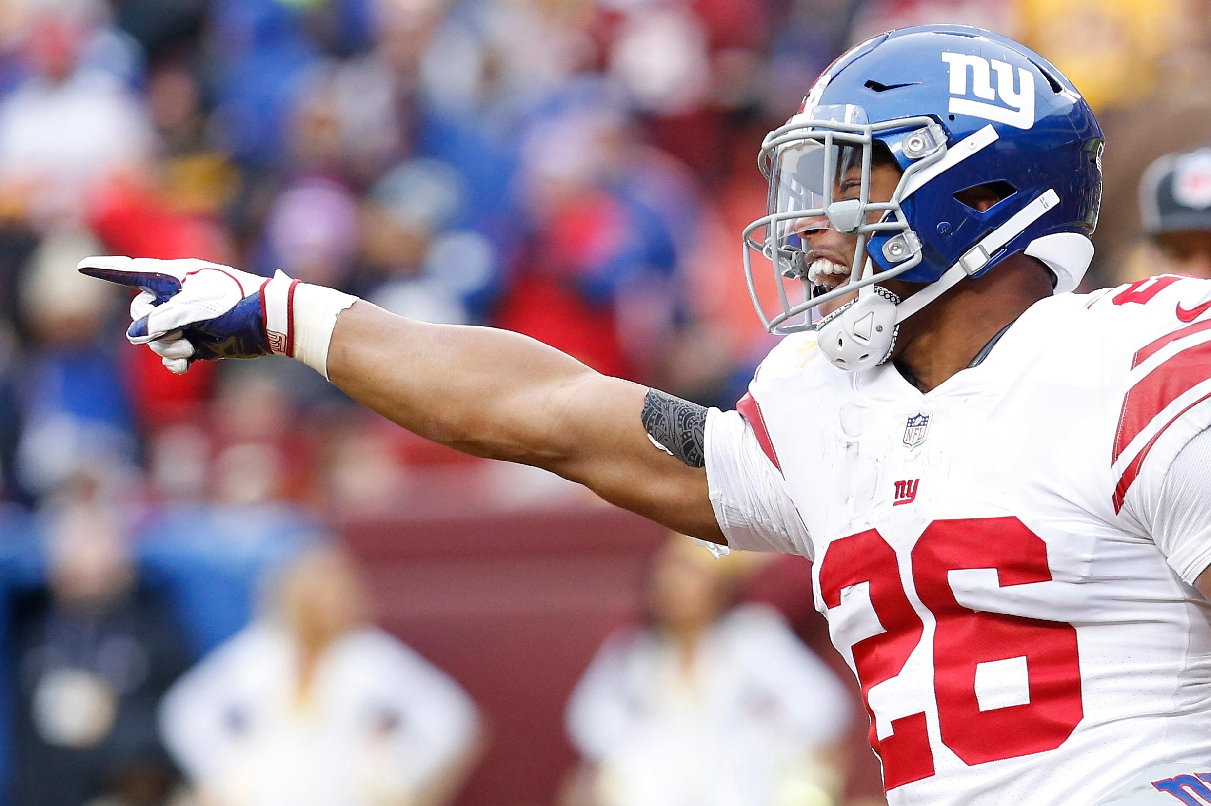 New York Giants running back Saquon Barkley celebrates after scoring a touchdown against the Washington Redskins in the second quarter at FedEx Field.