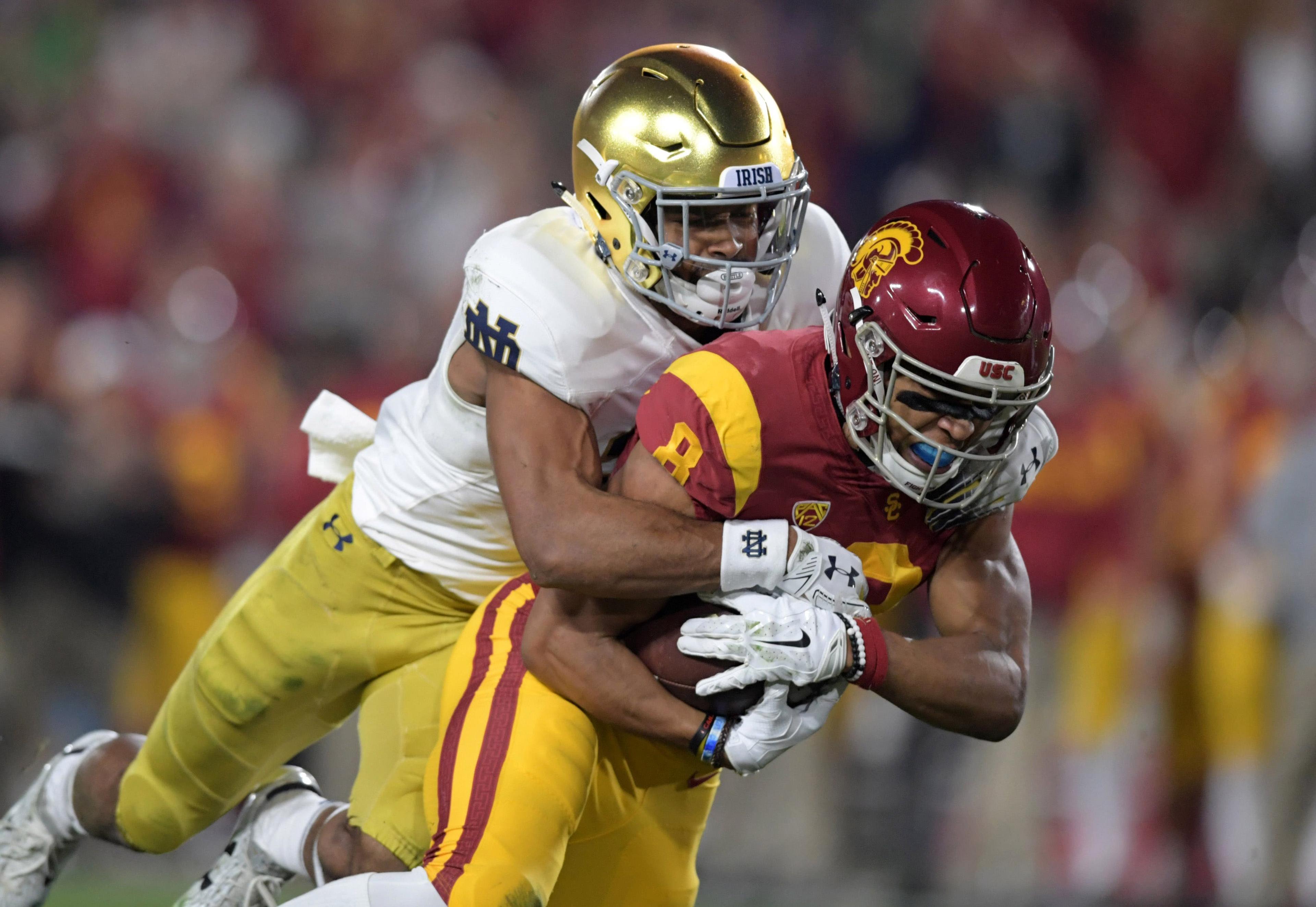 Nov 24, 2018; Los Angeles, CA, USA; Southern California Trojans wide receiver Amon-Ra St. Brown (8) is defended by Notre Dame Fighting Irish cornerback Julian Love (27) in the first quarter at Los Angeles Memorial Coliseum. Mandatory Credit: Kirby Lee-USA TODAY Sports / Kirby Lee