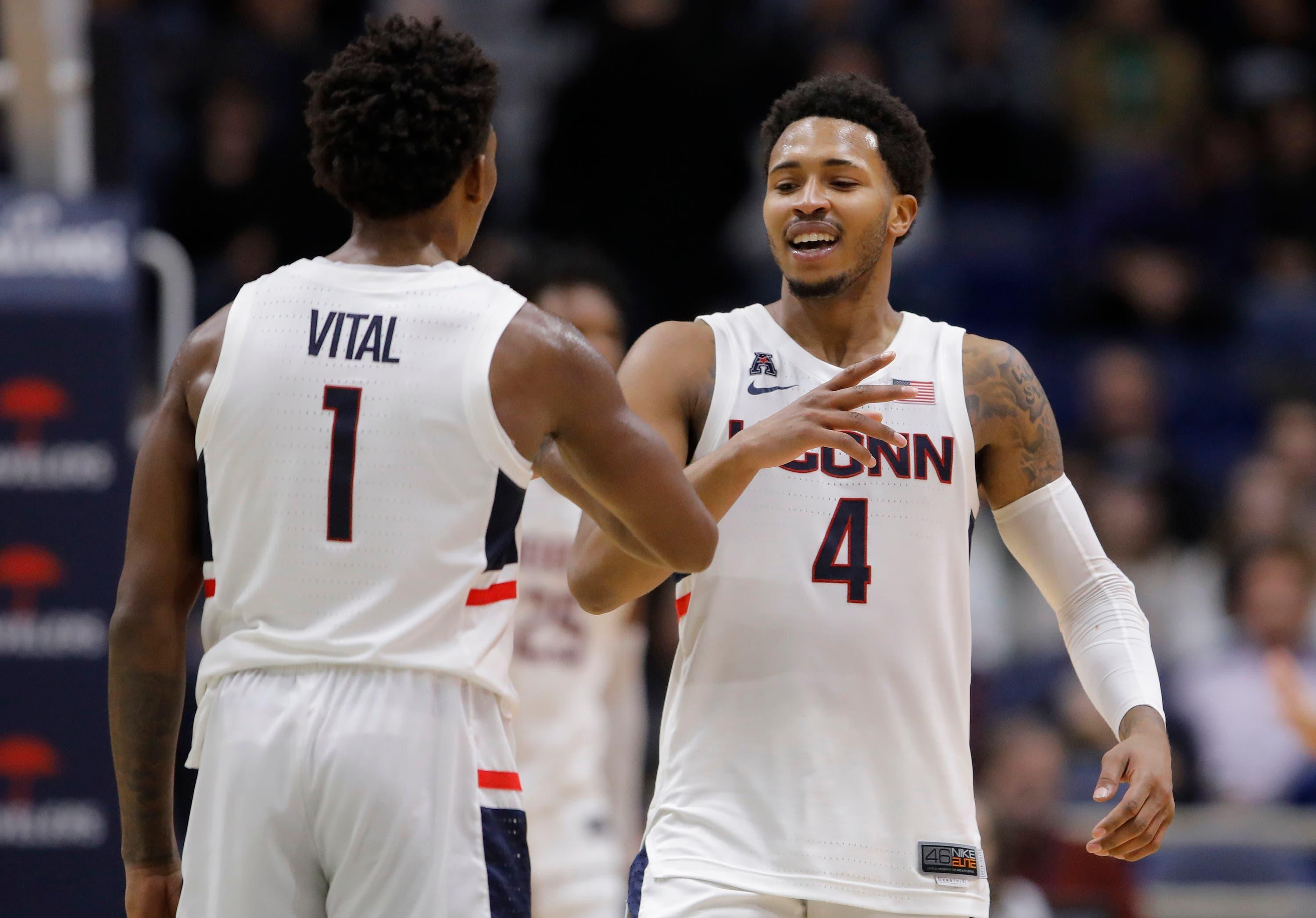 Connecticut Huskies guard Jalen Adams reacts with guard Christian Vital after a play against the Cornell Big Red in the second half at XL Center. / David Butler II/USA TODAY Sports