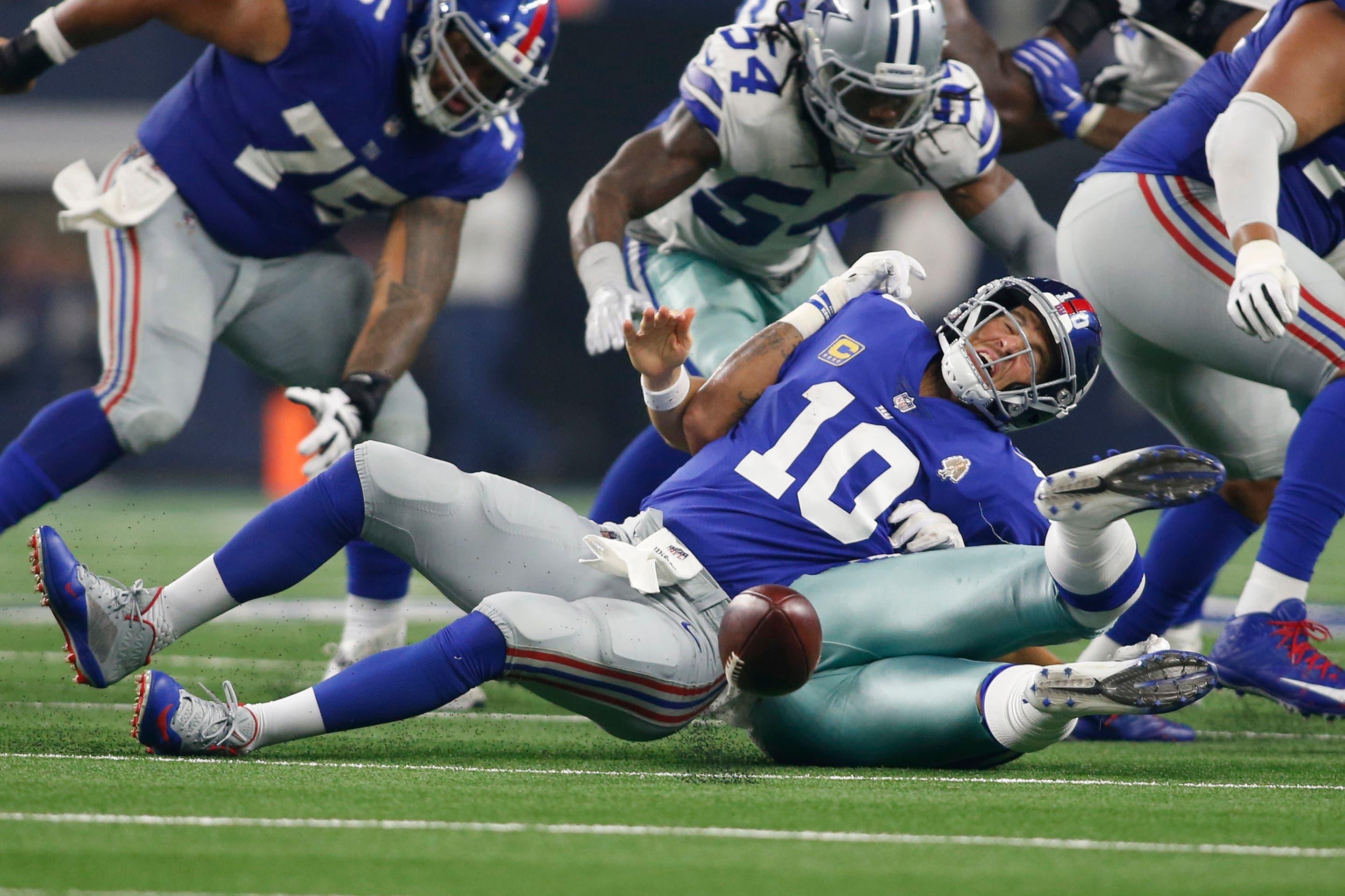 Sep 16, 2018; Arlington, TX, USA; Dallas Cowboys linebacker Damien Wilson (57) causes a fumble on a sack of New York Giants quarterback Eli Manning (10) in the third quarter at AT&T Stadium. Mandatory Credit: Tim Heitman-USA TODAY Sports / Tim Heitman