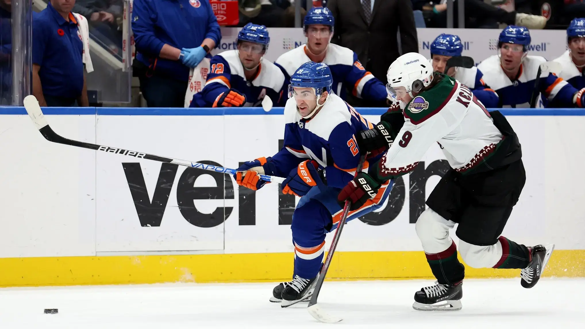 Nov 10, 2022; Elmont, New York, USA; New York Islanders center Kyle Palmieri (21) and Arizona Coyotes right wing Clayton Keller (9) fight for the puck during the second period at UBS Arena. / Brad Penner-USA TODAY Sports