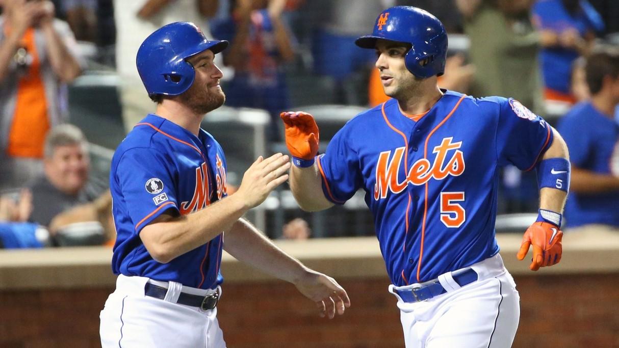 Jul 11, 2014; New York, NY, USA; New York Mets second baseman Daniel Murphy (28) and third baseman David Wright (5) celebrate scoring during the fifth inning against the Miami Marlins at Citi Field. 