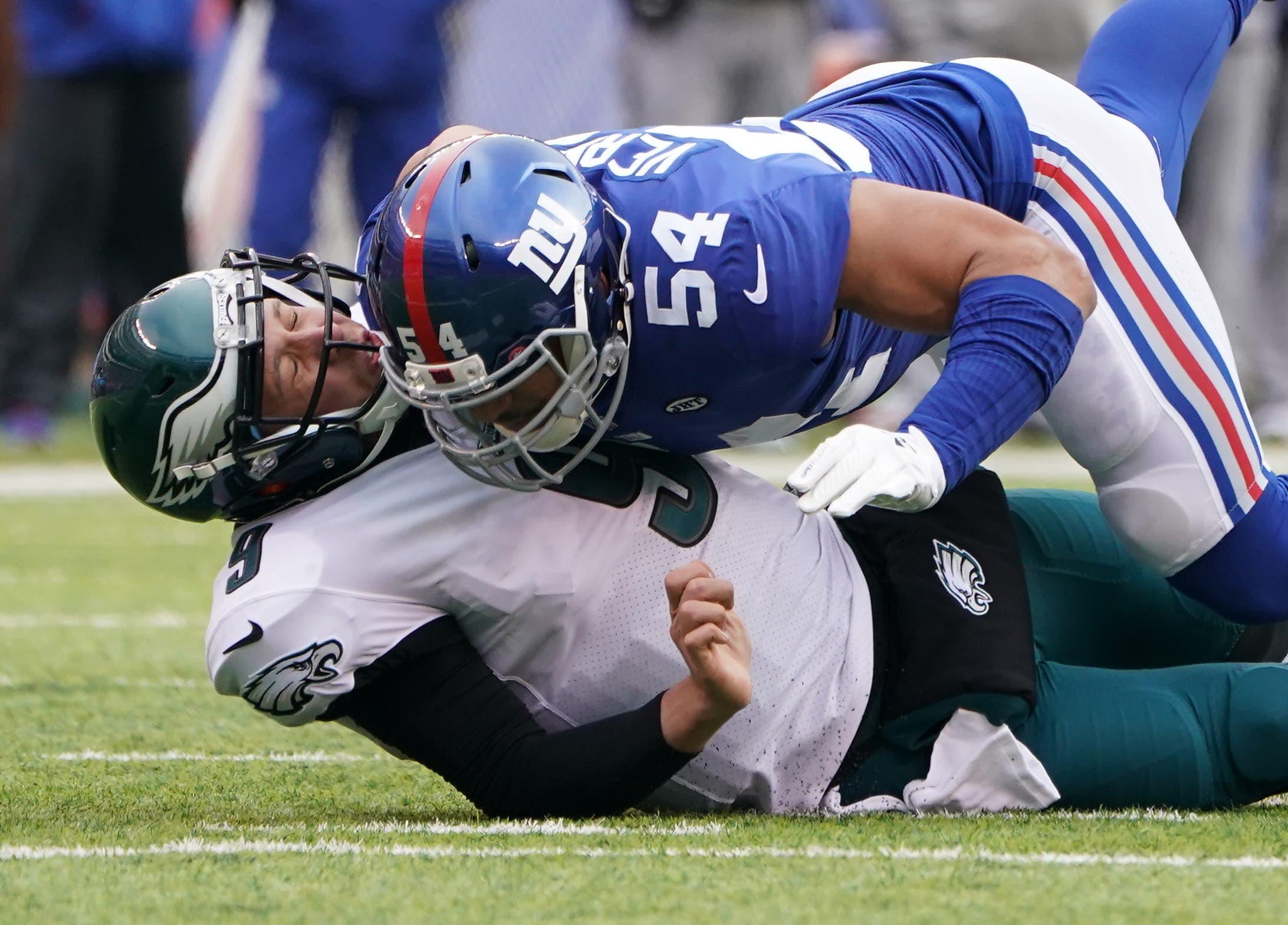 Dec 17, 2017; East Rutherford, NJ, USA; 
Philadelphia Eagles quarterback Nick Foles (9) is hit after the throw by New York Giants defensive end Olivier Vernon (54) in the first half at MetLife Stadium. Mandatory Credit: Robert Deutsch-USA TODAY Sports / Robert Deutsch