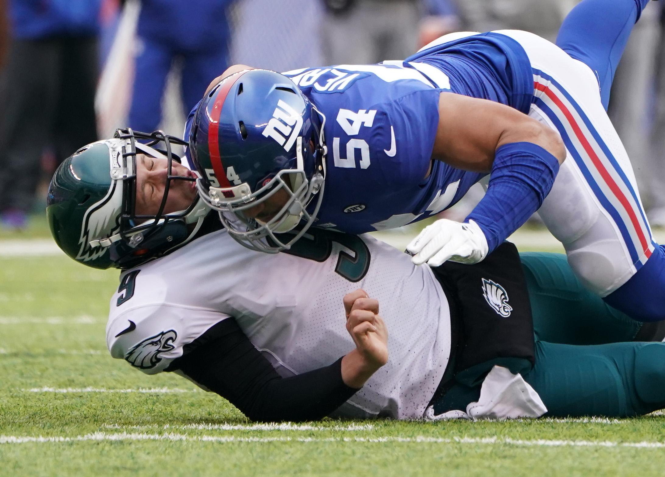 Dec 17, 2017; East Rutherford, NJ, USA; 
Philadelphia Eagles quarterback Nick Foles (9) is hit after the throw by New York Giants defensive end Olivier Vernon (54) in the first half at MetLife Stadium. Mandatory Credit: Robert Deutsch-USA TODAY Sports