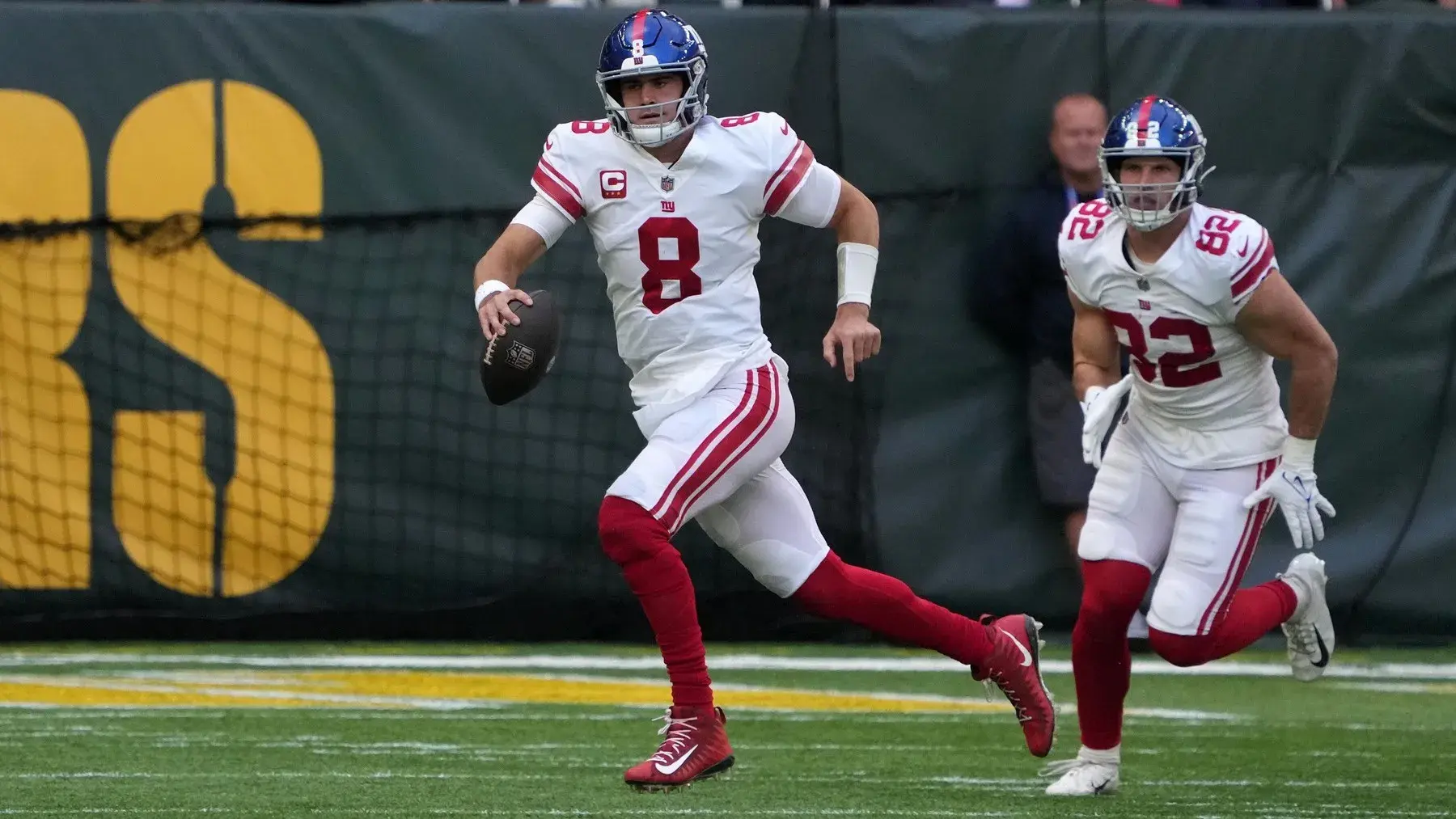 Oct 9, 2022; London, United Kingdom; New York Giants quarterback Daniel Jones (8) carries the ball in the second quarter against the Green Bay Packers during an NFL International Series game at Tottenham Hotspur Stadium. / Kirby Lee-USA TODAY Sports