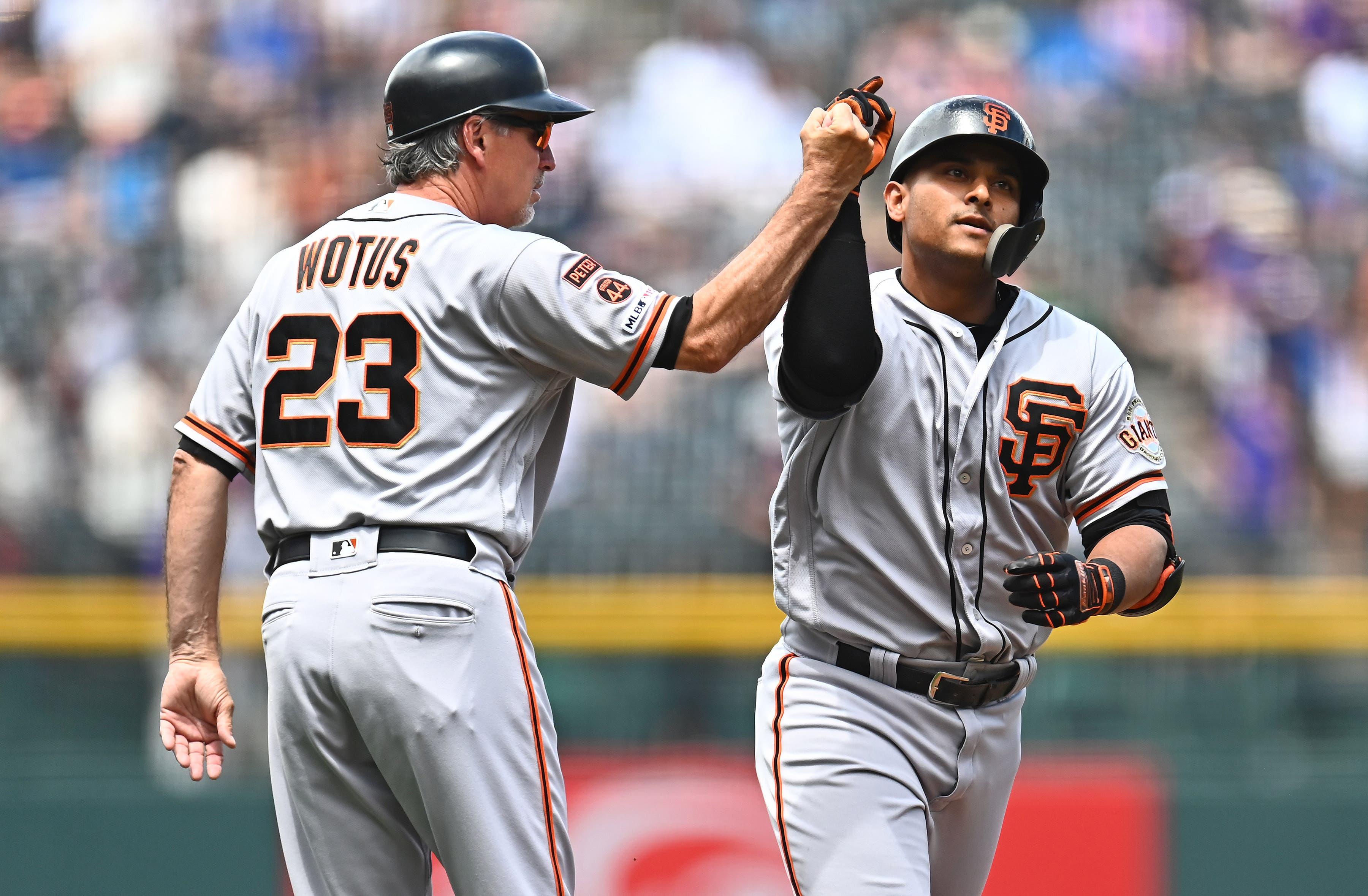 Aug 4, 2019; Denver, CO, USA; San Francisco Giants shortstop Donovan Solano (7) celebrates his solo home run with third base coach Ron Wotus (23) in the first inning against the Colorado Rockies at Coors Field. Mandatory Credit: Ron Chenoy-USA TODAY Sports / Ron Chenoy