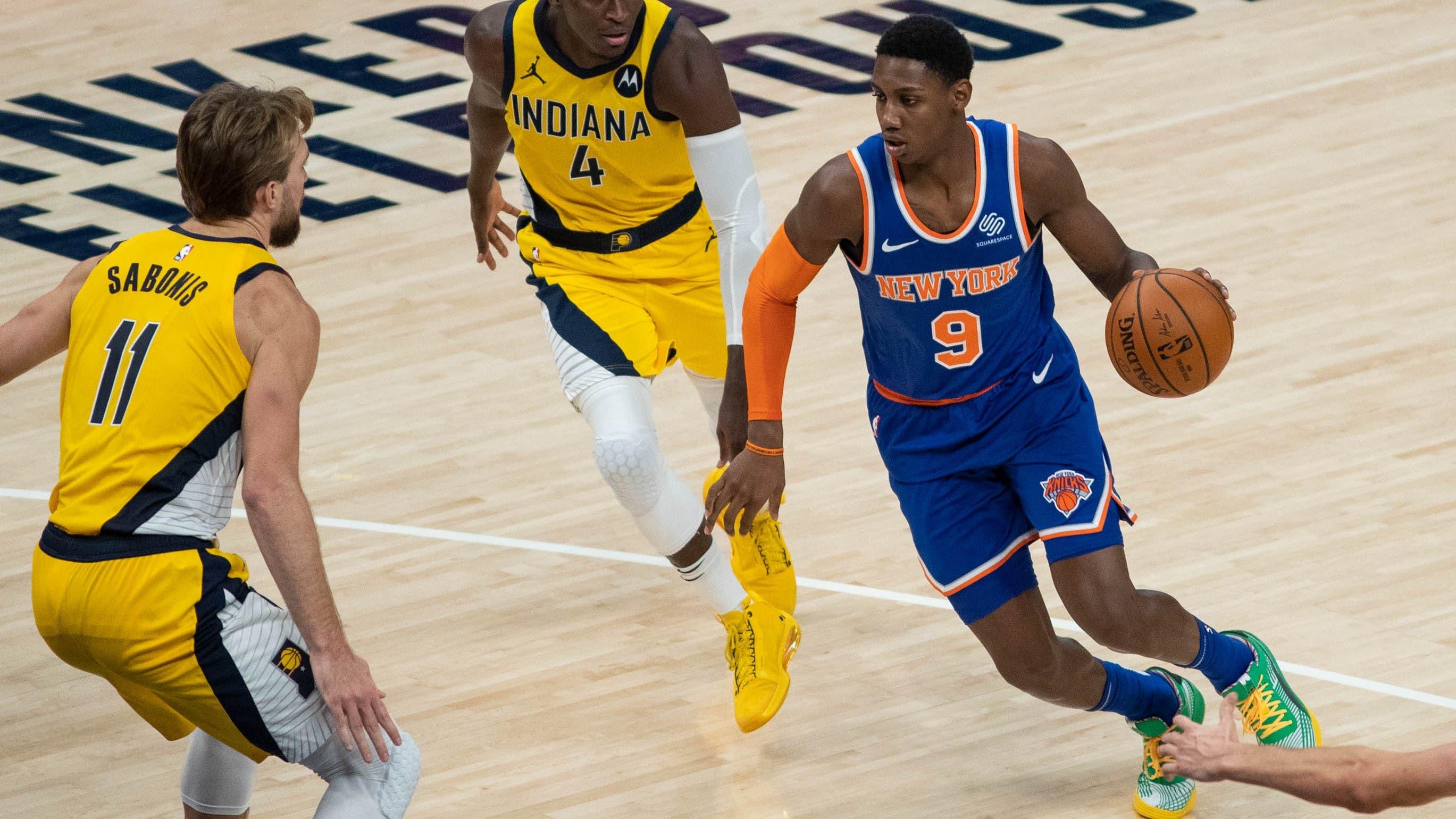 New York Knicks guard RJ Barrett (9) dribbles the ball while Indiana Pacers guard Victor Oladipo (4) defends in the fourth quarter at Bankers Life Fieldhouse. / Trevor Ruszkowski