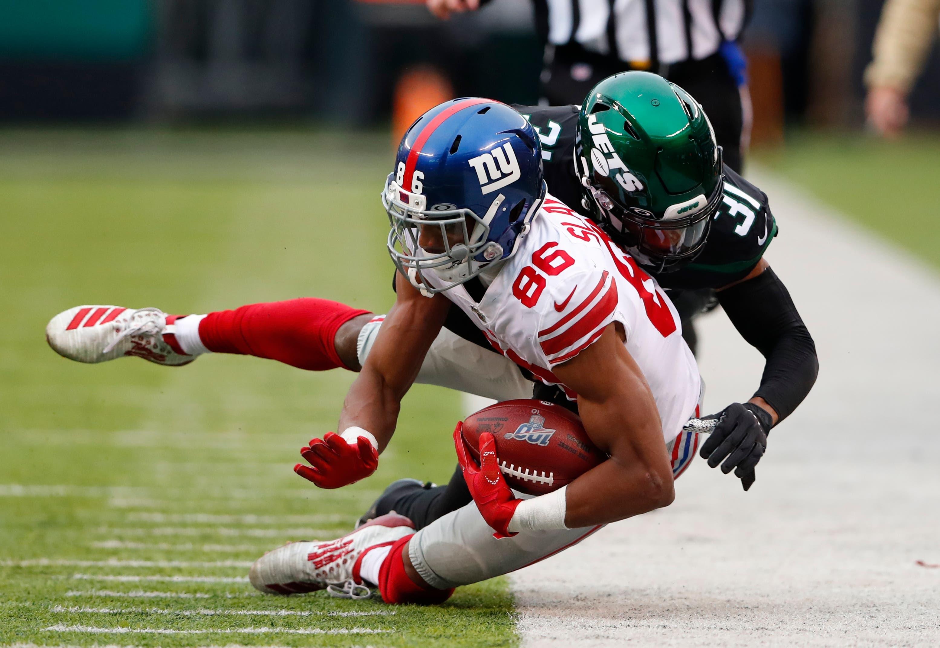 Nov 10, 2019; East Rutherford, NJ, USA; New York Giants wide receiver Darius Slayton (86) is tackled by New York Jets defensive back Blessuan Austin (31) during the second half at MetLife Stadium. Mandatory Credit: Noah K. Murray-USA TODAY Sports / Noah K. Murray