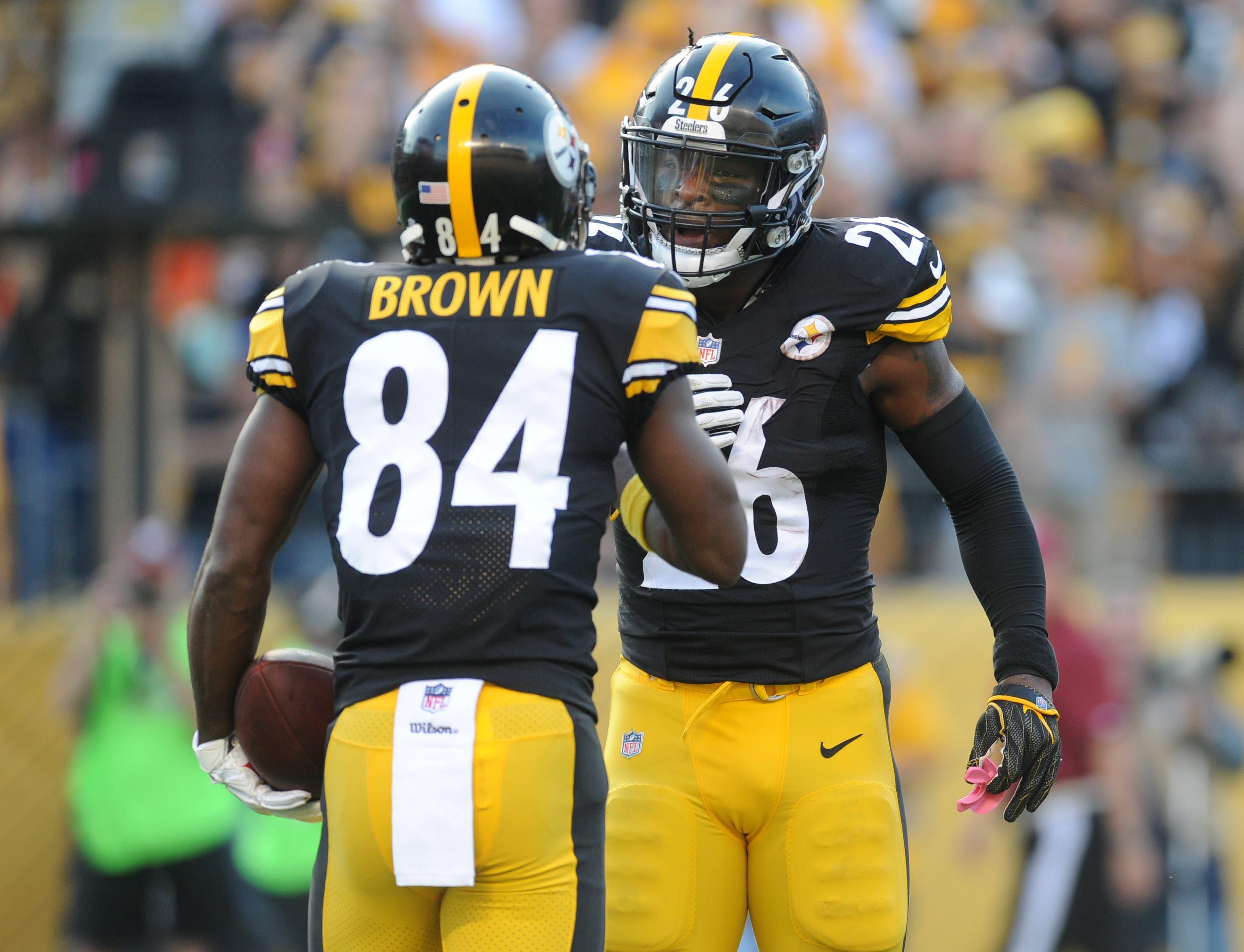 Oct 22, 2017; Pittsburgh, PA, USA; Pittsburgh Steelers running back Le'Veon Bell (26) greets wide receiver Antonio Brown (84) after a first quarter touchdown against the Cincinnati Bengals at Heinz Field. Mandatory Credit: Philip G. Pavely-USA TODAY Sports / Philip G. Pavely