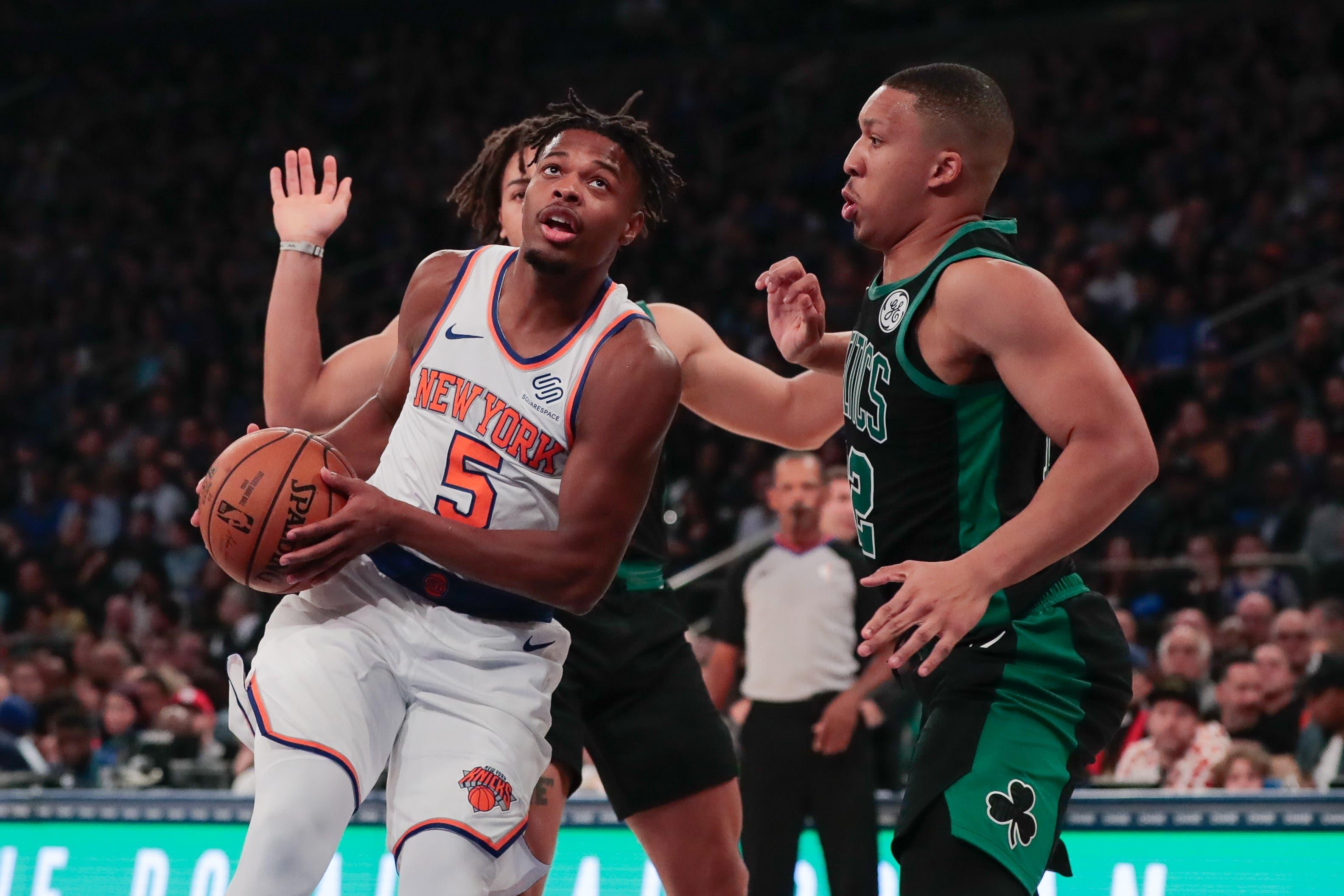 Oct 26, 2019; New York, NY, USA; New York Knicks guard Dennis Smith Jr. (5) drives to the basket as Boston Celtics forward Grant Williams (12) defends during the first half at Madison Square Garden. Mandatory Credit: Vincent Carchietta-USA TODAY Sportsundefined