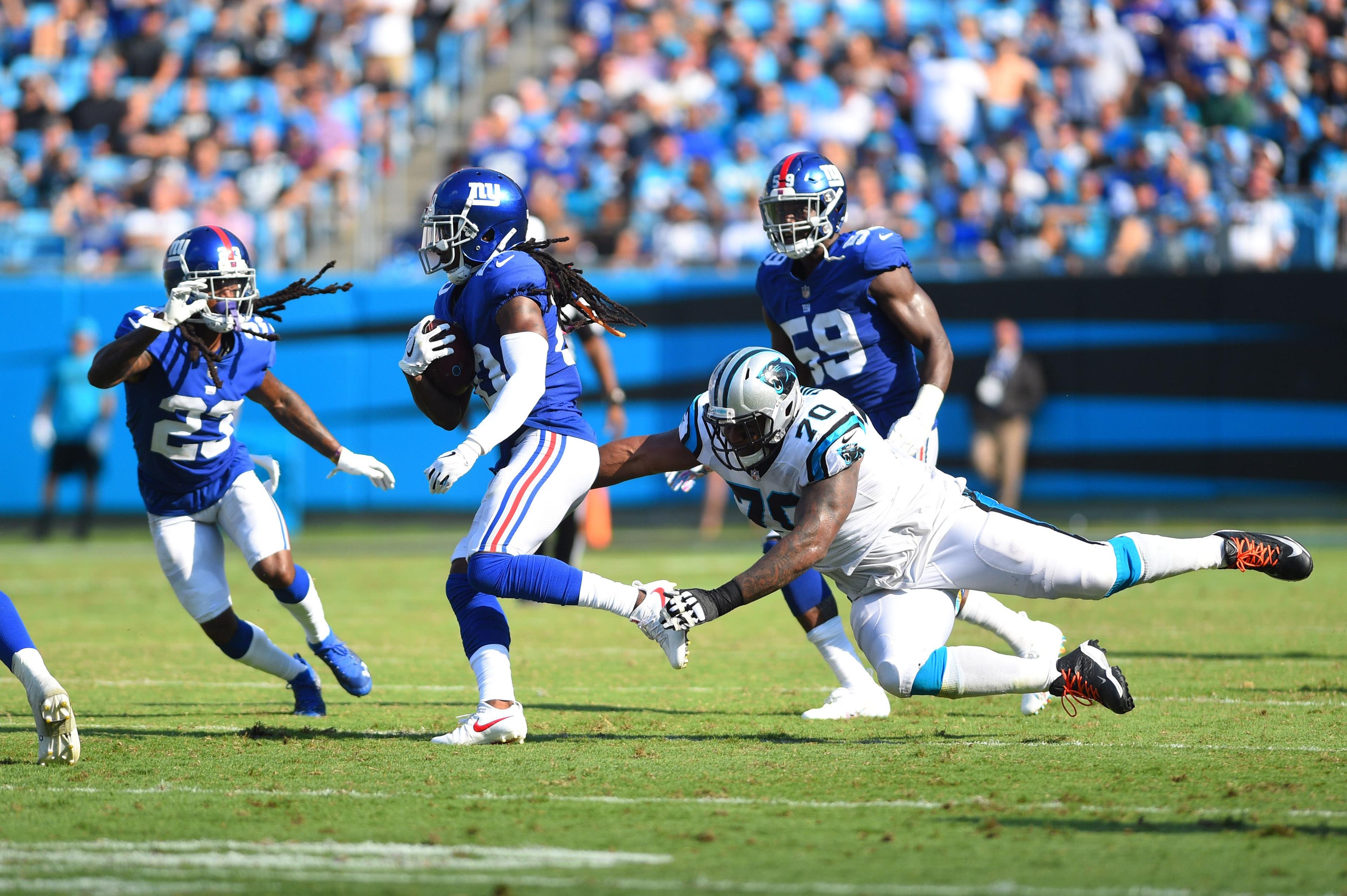 Oct 7, 2018; Charlotte, NC, USA; New York Giants cornerback Janoris Jenkins (20) with an interception as cornerback B.W. Webb (23) looks on and Carolina Panthers offensive guard Trai Turner (70) defends in the fourth quarter at Bank of America Stadium. Mandatory Credit: Bob Donnan-USA TODAY Sports / Bob Donnan