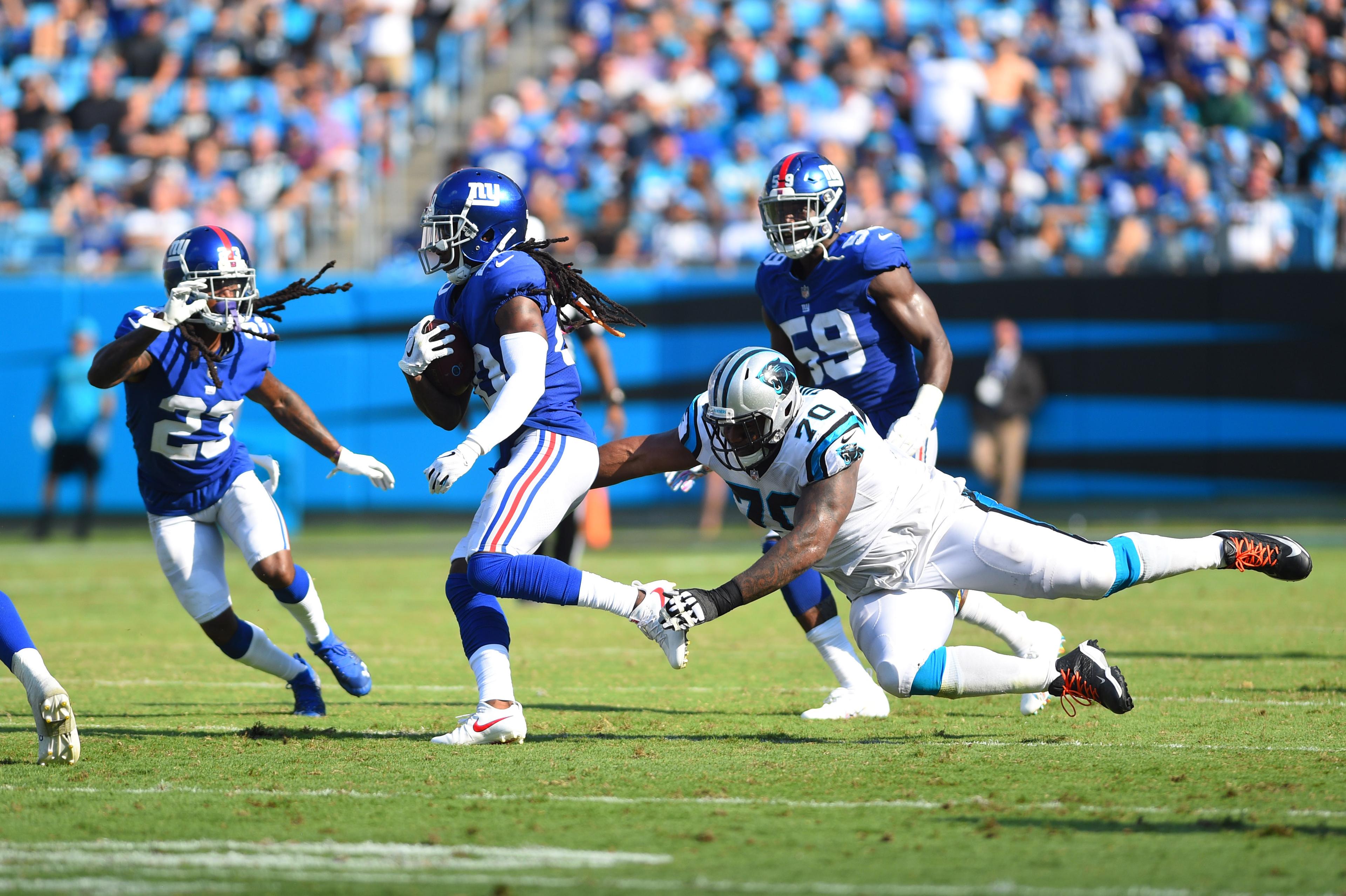 Oct 7, 2018; Charlotte, NC, USA; New York Giants cornerback Janoris Jenkins (20) with an interception as cornerback B.W. Webb (23) looks on and Carolina Panthers offensive guard Trai Turner (70) defends in the fourth quarter at Bank of America Stadium. Mandatory Credit: Bob Donnan-USA TODAY Sports