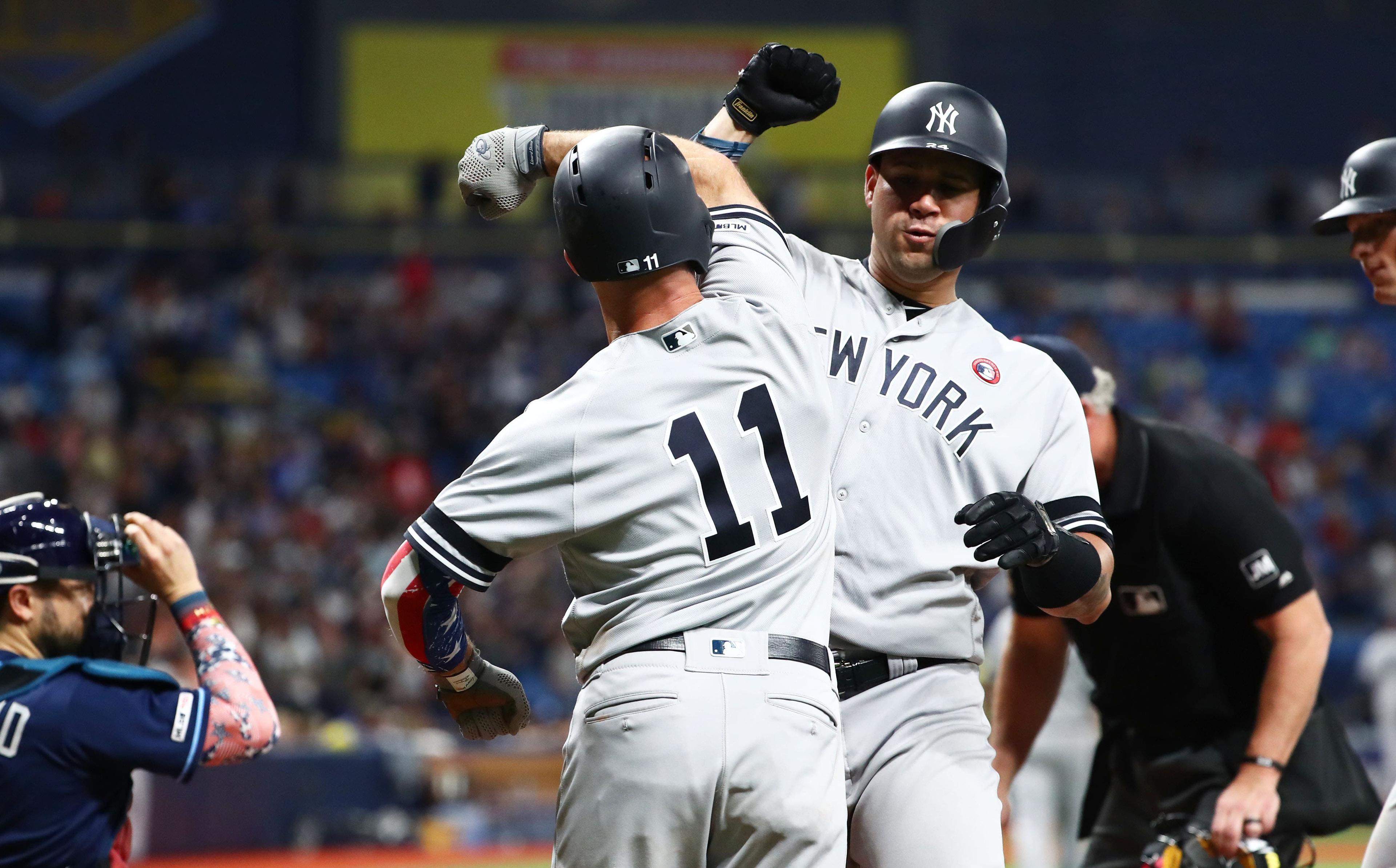 New York Yankees catcher Gary Sanchez is congratulated by New York Yankees left fielder Brett Gardner as he hits a three-run home run during the 10th inning against the Tampa Bay Rays at Tropicana Field. / Kim Klement/USA TODAY Sports