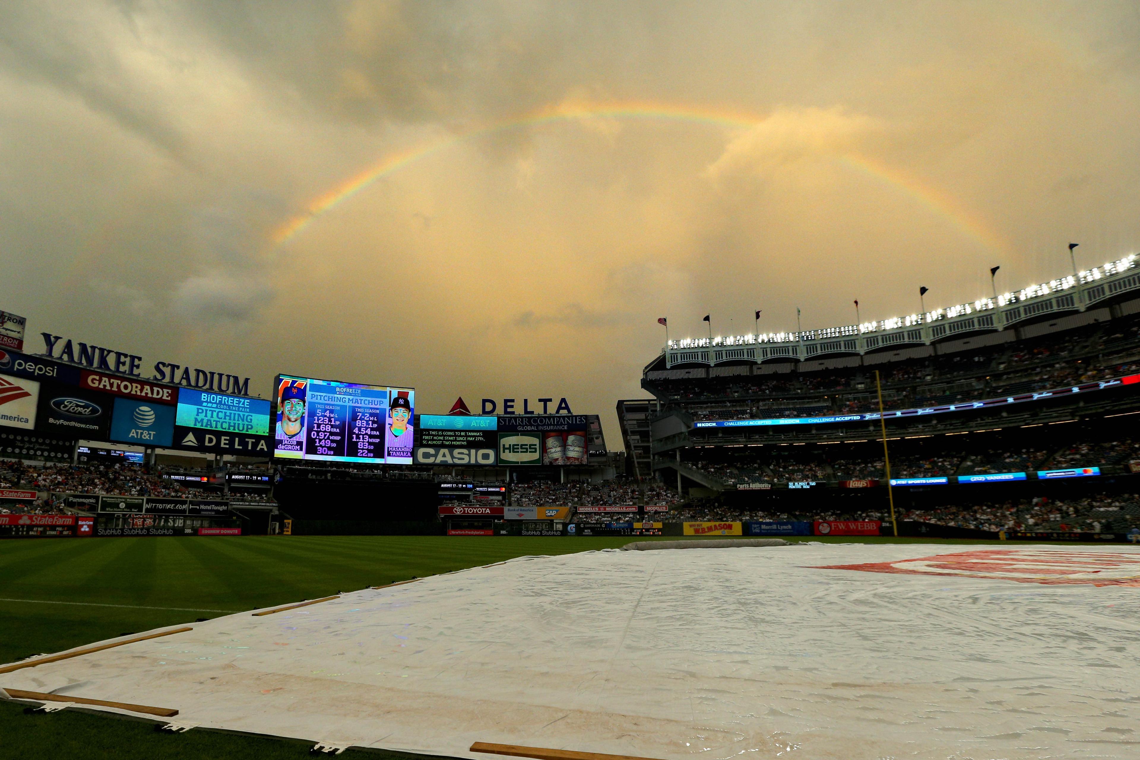 General view of the tarp on the field during a rain delay before a game between the New York Yankees and the New York Mets at Yankee Stadium. / Brad Penner/USA TODAY Sports