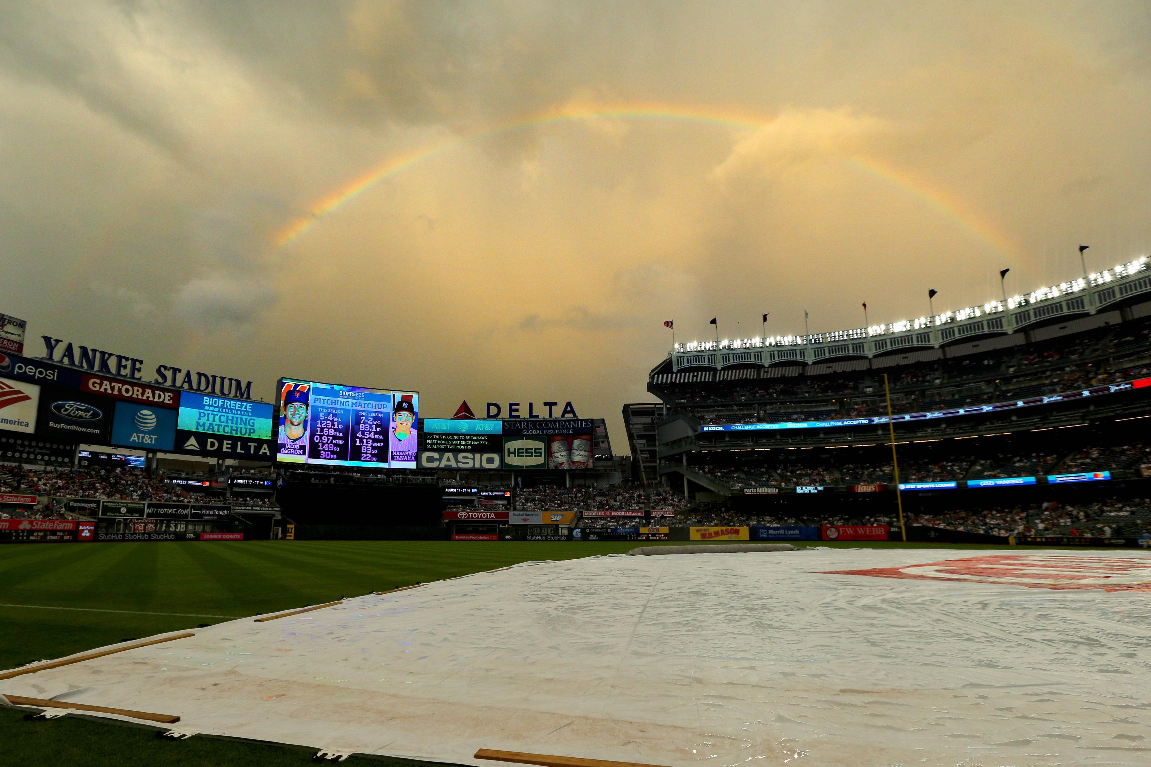 General view of the tarp on the field during a rain delay before a game between the New York Yankees and the New York Mets at Yankee Stadium.