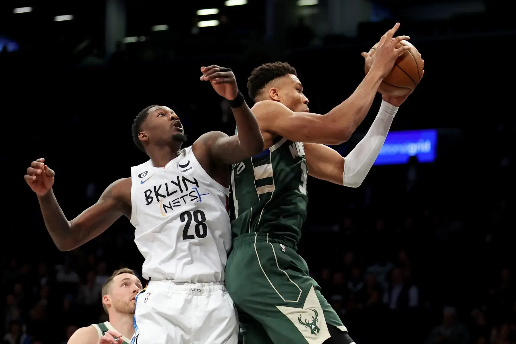 Milwaukee Bucks forward Giannis Antetokounmpo (34) grabs a rebound against Brooklyn Nets forward Dorian Finney-Smith (28) during the first quarter at Barclays Center. / Brad Penner-USA TODAY Sports