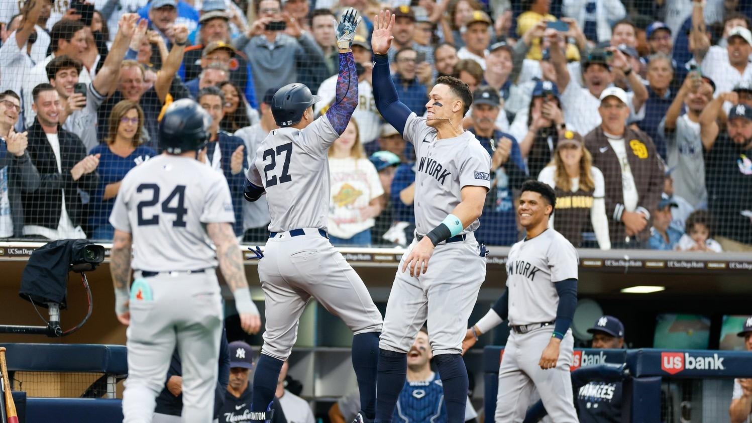 New York Yankees designated hitter Giancarlo Stanton (27) celebrates with New York Yankees center fielder Aaron Judge (99) after hitting a two-run home run in the third inning against the San Diego Padres at Petco Park. / David Frerker-USA TODAY Sports