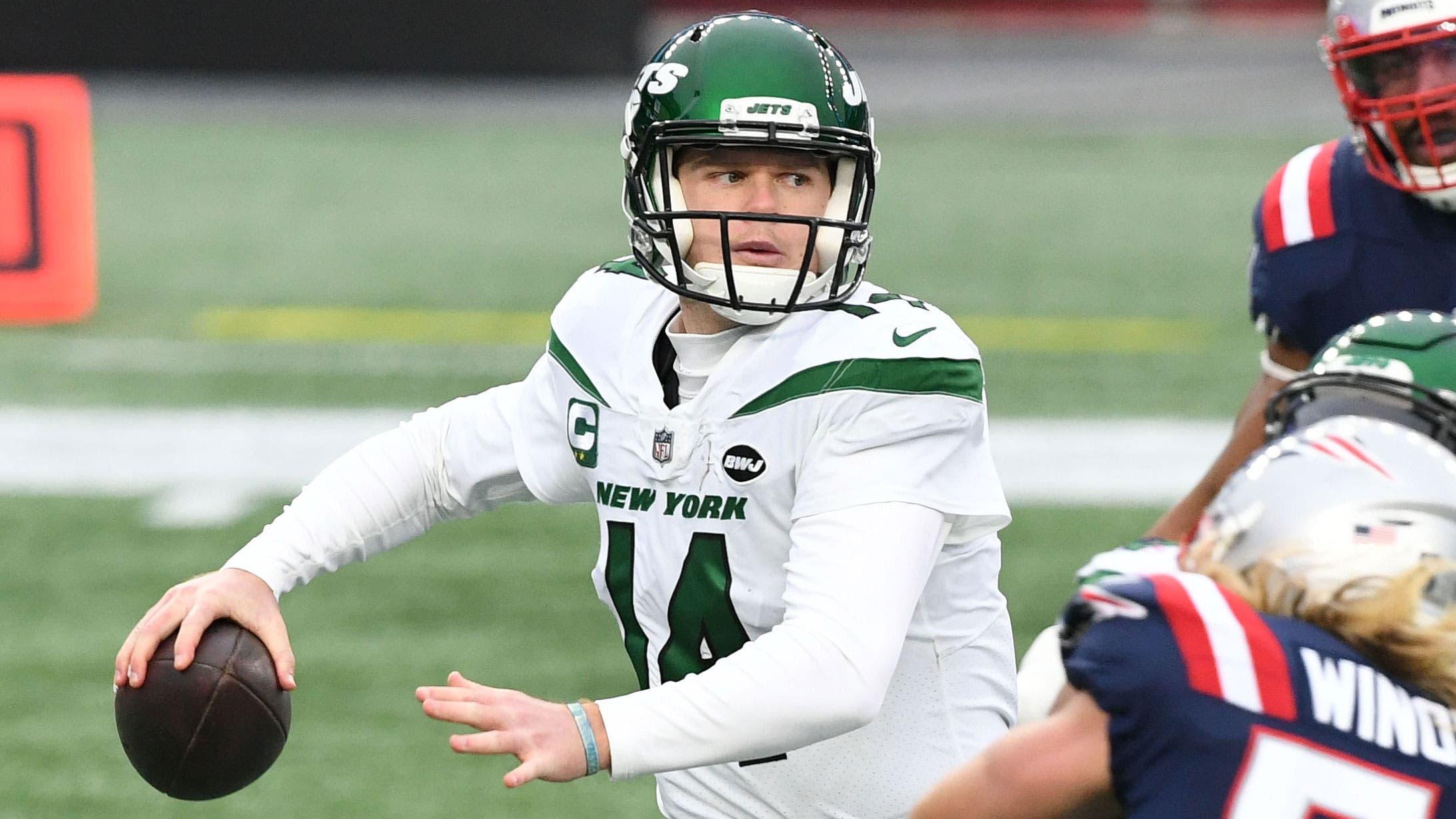 Jan 3, 2021; Foxborough, Massachusetts, USA; New York Jets quarterback Sam Darnold (14) looks to pass under pressure from New England Patriots defensive end Chase Winovich (50) during the second quarter at Gillette Stadium. / Brian Fluharty-USA TODAY Sports