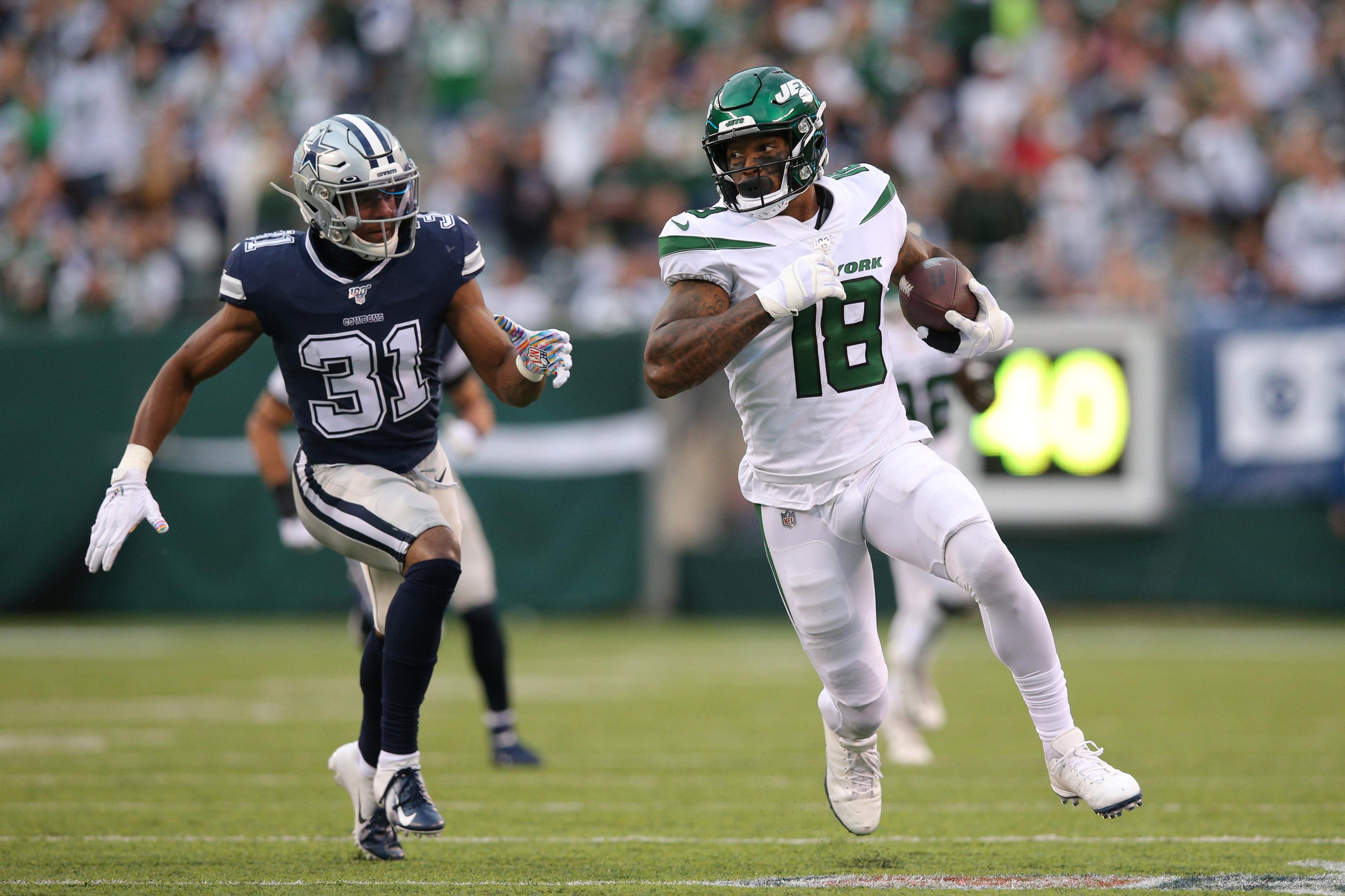 Oct 13, 2019; East Rutherford, NJ, USA; New York Jets wide receiver Demaryius Thomas (18) runs the ball against Dallas Cowboys cornerback Byron Jones (31) during the second quarter at MetLife Stadium. Mandatory Credit: Brad Penner-USA TODAY Sports / Brad Penner