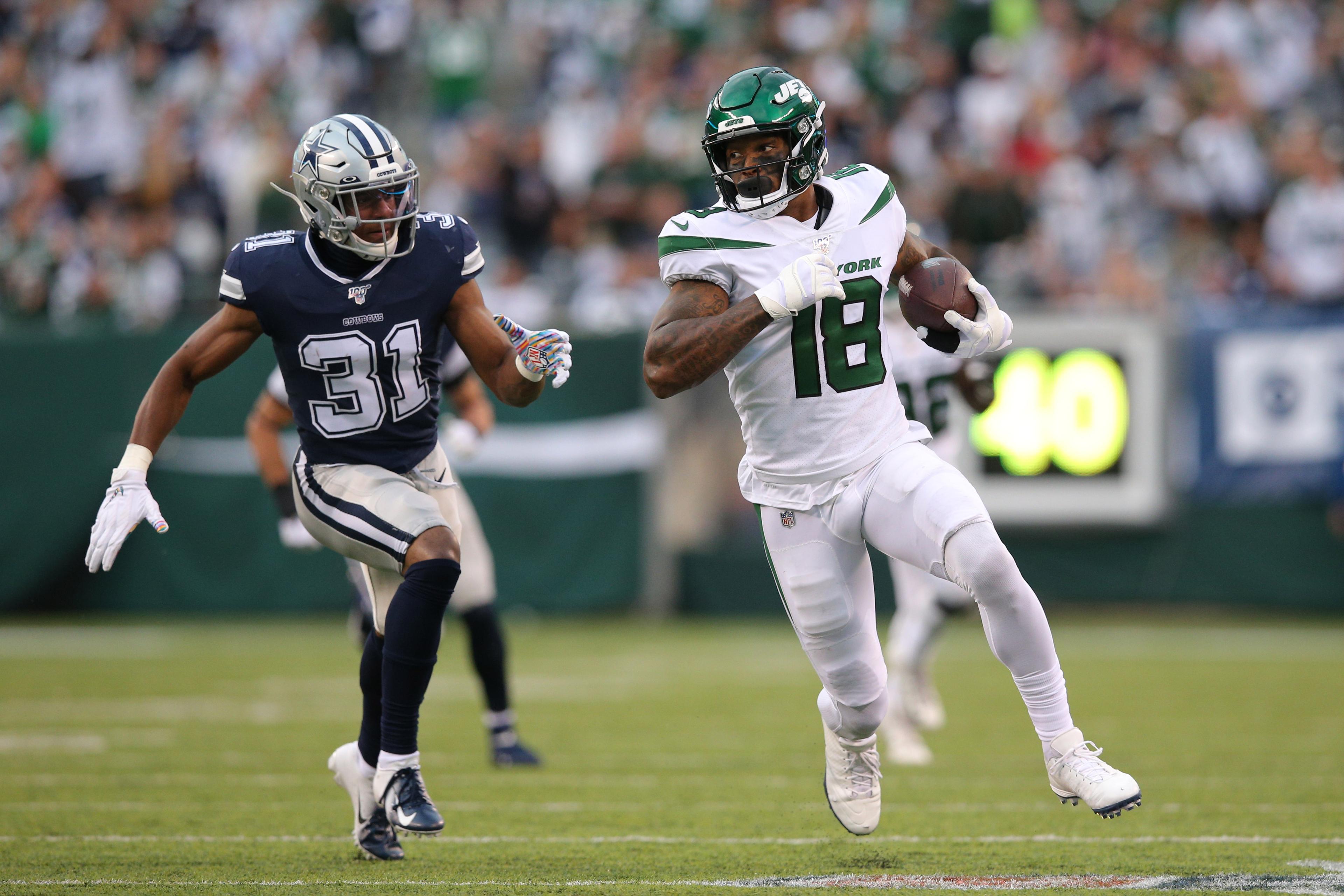 Oct 13, 2019; East Rutherford, NJ, USA; New York Jets wide receiver Demaryius Thomas (18) runs the ball against Dallas Cowboys cornerback Byron Jones (31) during the second quarter at MetLife Stadium. Mandatory Credit: Brad Penner-USA TODAY Sports