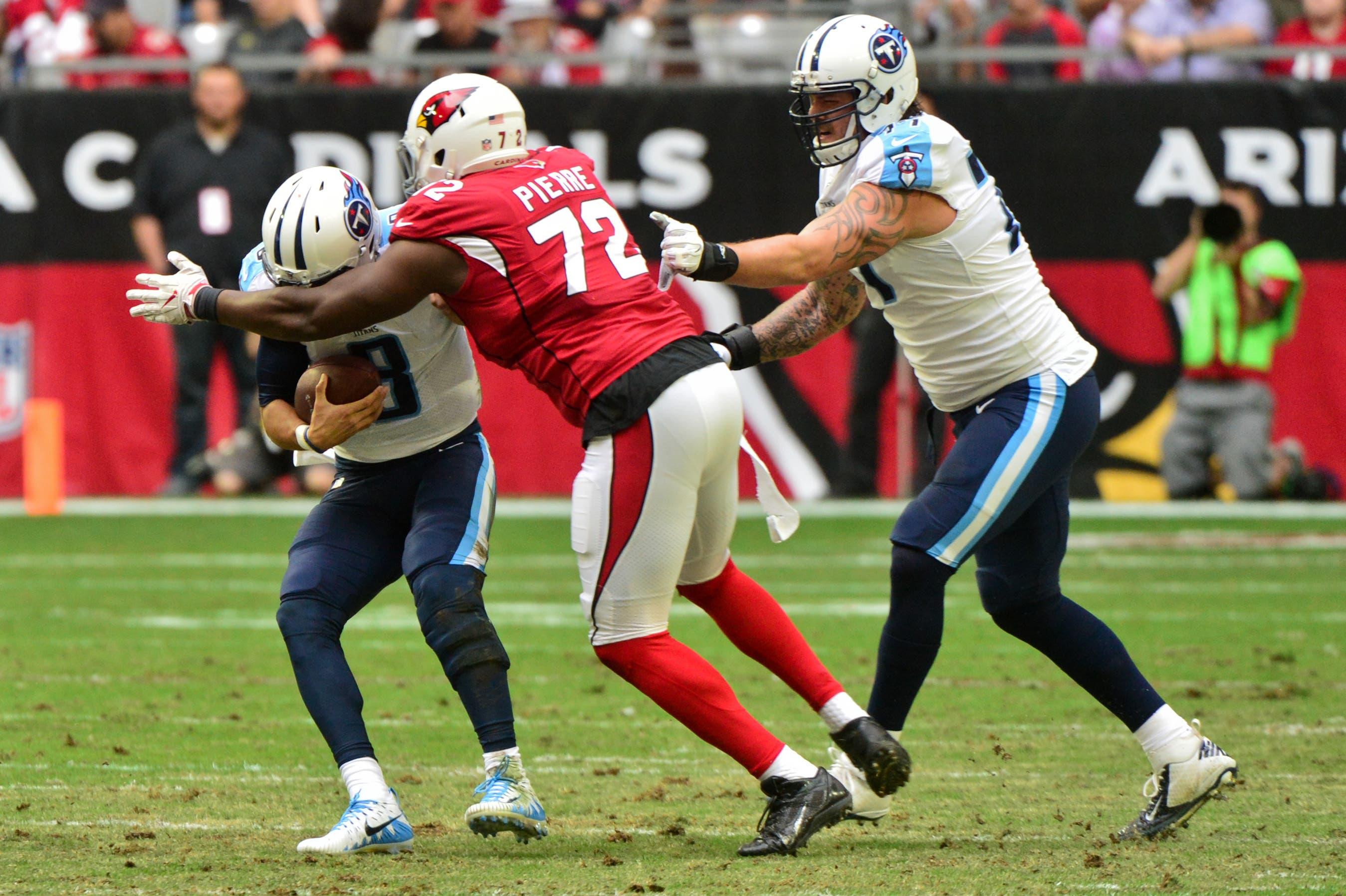 Dec 10, 2017; Glendale, AZ, USA; Arizona Cardinals defensive tackle Olsen Pierre (72) sacks Tennessee Titans quarterback Marcus Mariota (8) during the first half at University of Phoenix Stadium. Mandatory Credit: Matt Kartozian-USA TODAY Sports / Matt Kartozian