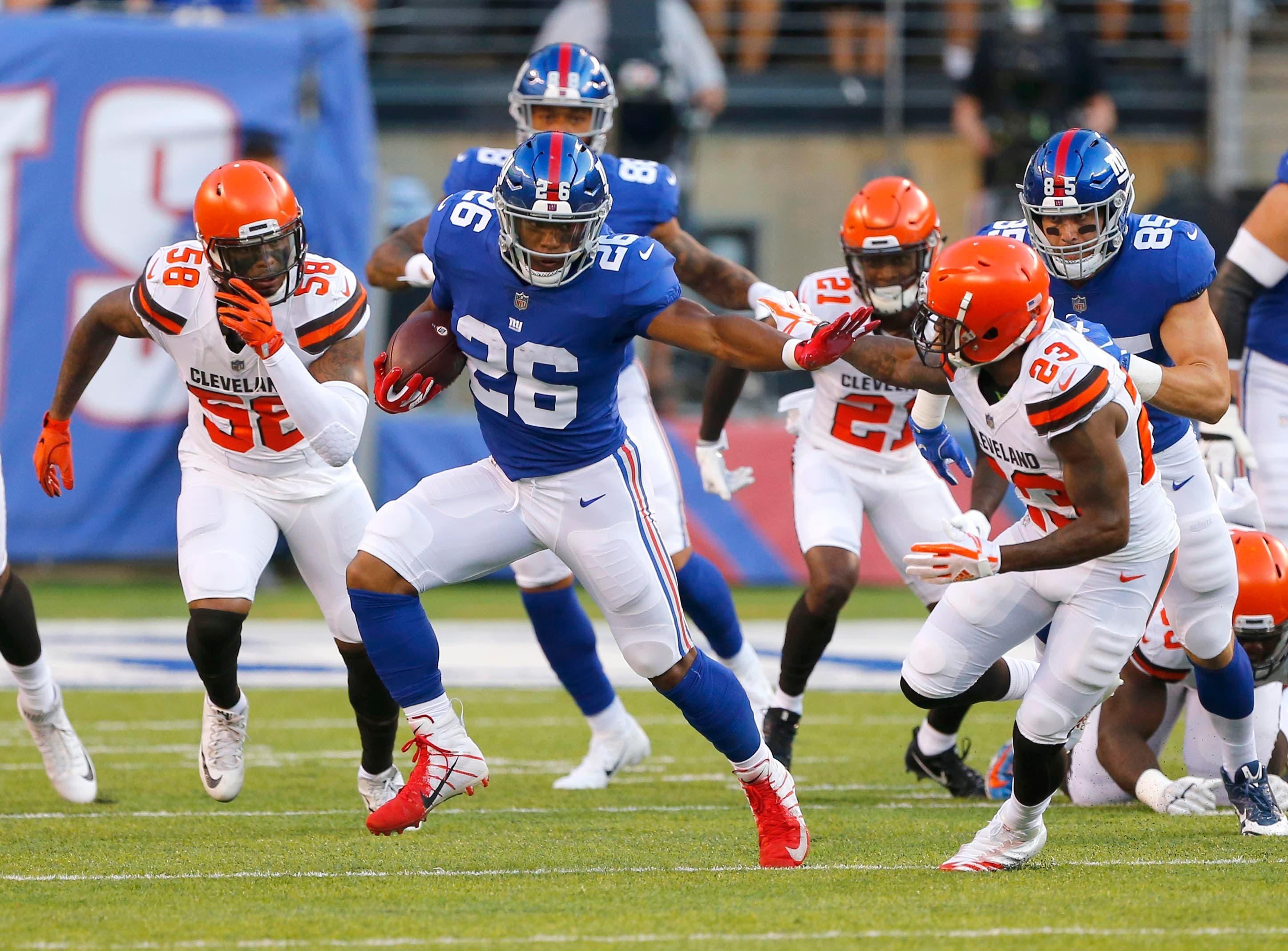 Aug 9, 2018; East Rutherford, NJ, USA; New York Giants running back Saquon Barkley (26) rushes against Cleveland Browns defensive back Damarious Randall (23) during first half at MetLife Stadium. Mandatory Credit: Noah K. Murray-USA TODAY Sports / Noah K. Murray