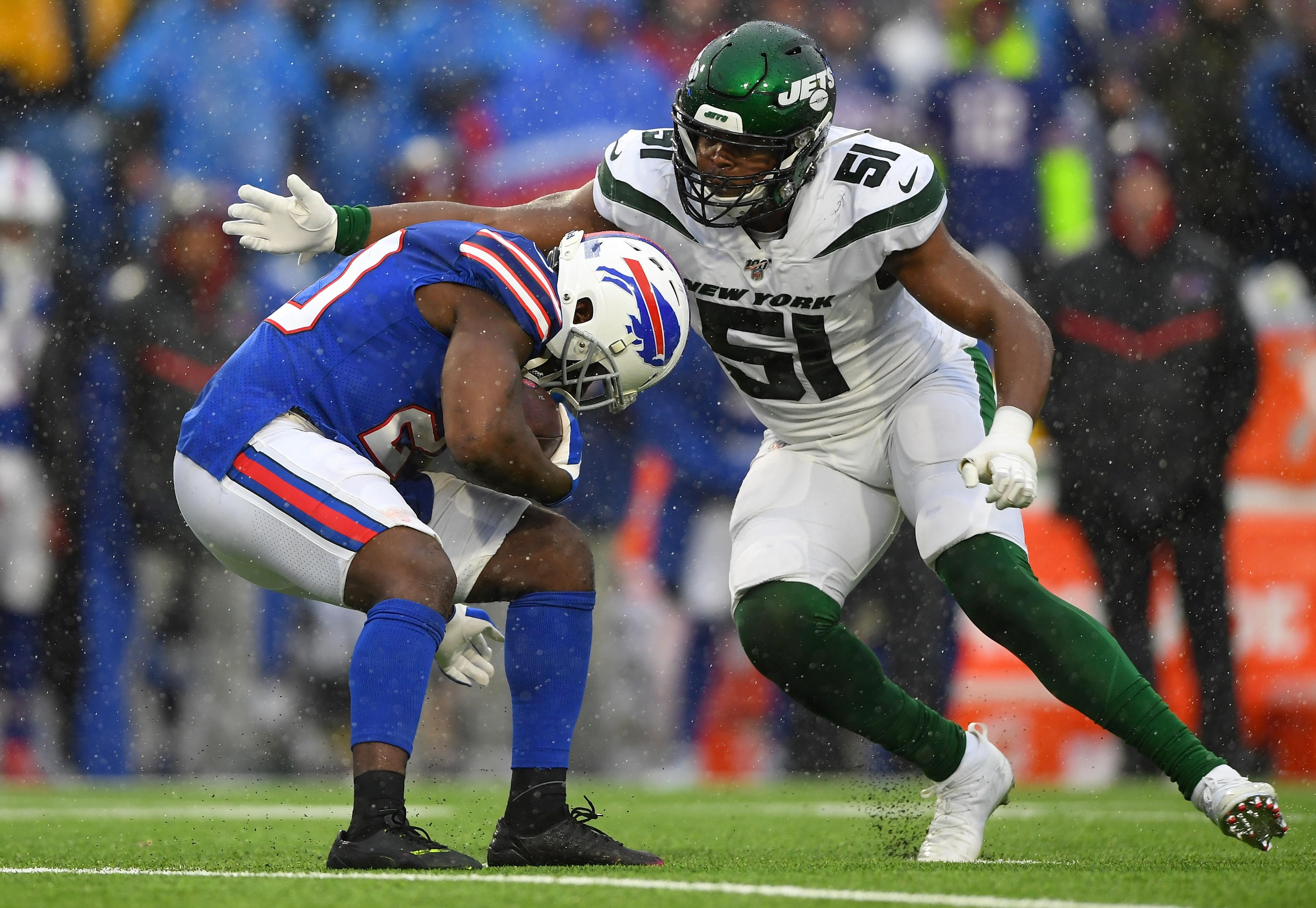 Dec 29, 2019; Orchard Park, New York, USA; Buffalo Bills running back Frank Gore (20) avoids the tackle attempt of New York Jets outside linebacker Brandon Copeland (51) during the second quarter at New Era Field. Mandatory Credit: Rich Barnes-USA TODAY Sports