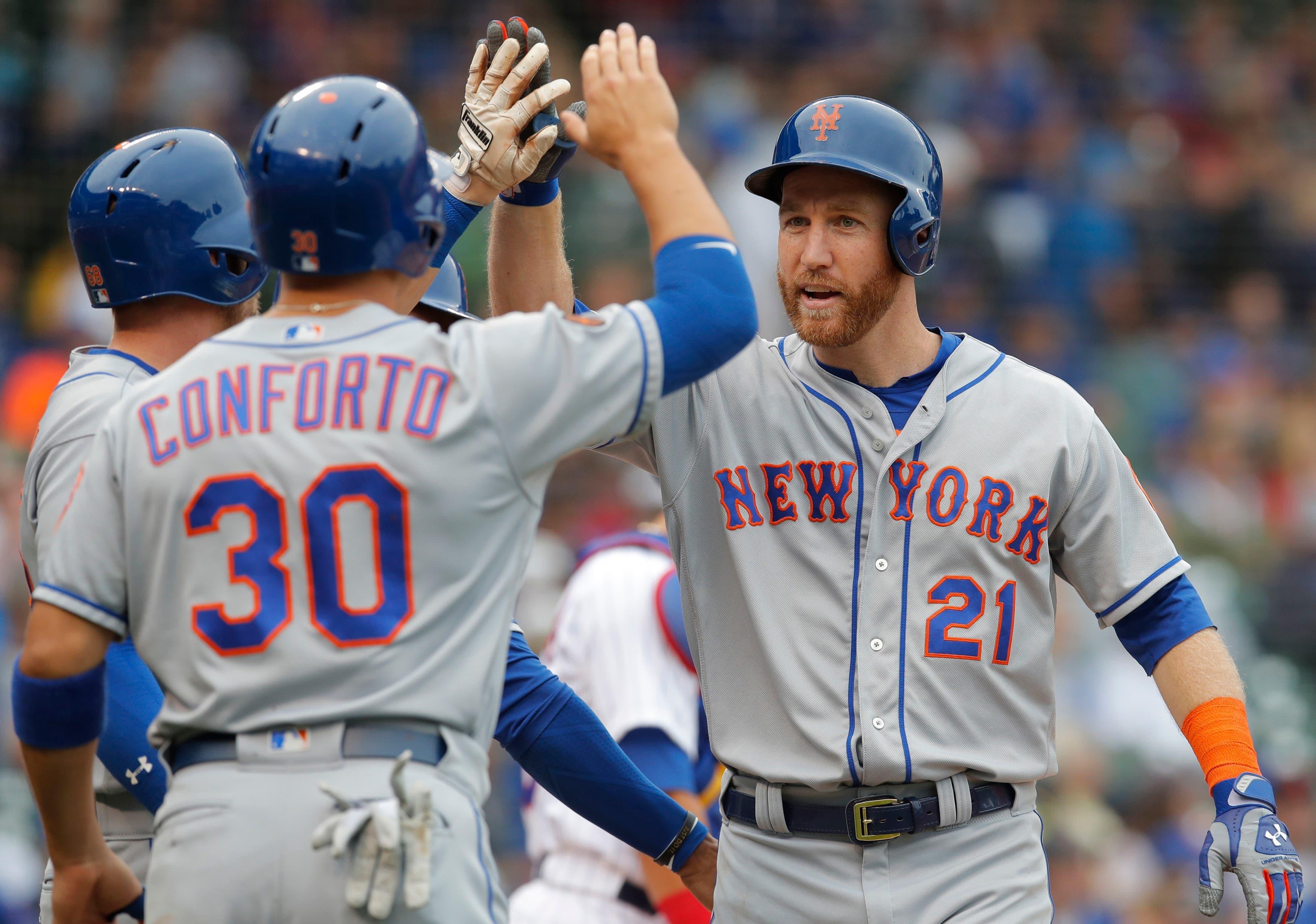 Aug 29, 2018; Chicago, IL, USA; New York Mets third baseman Todd Frazier (21) celebrates with left fielder Michael Conforto (30) after hitting a grand slam home run against the Chicago Cubs during the first inning at Wrigley Field. Mandatory Credit: Jim Young-USA TODAY Sports / Jim Young