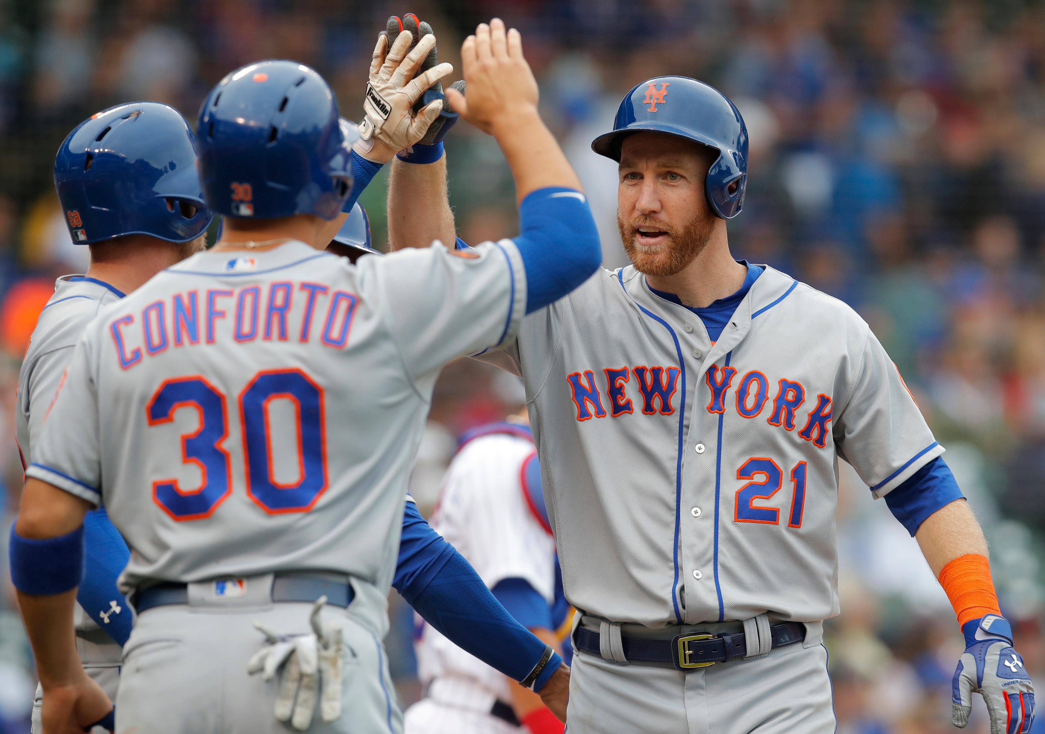 Aug 29, 2018; Chicago, IL, USA; New York Mets third baseman Todd Frazier (21) celebrates with left fielder Michael Conforto (30) after hitting a grand slam home run against the Chicago Cubs during the first inning at Wrigley Field. Mandatory Credit: Jim Young-USA TODAY Sports