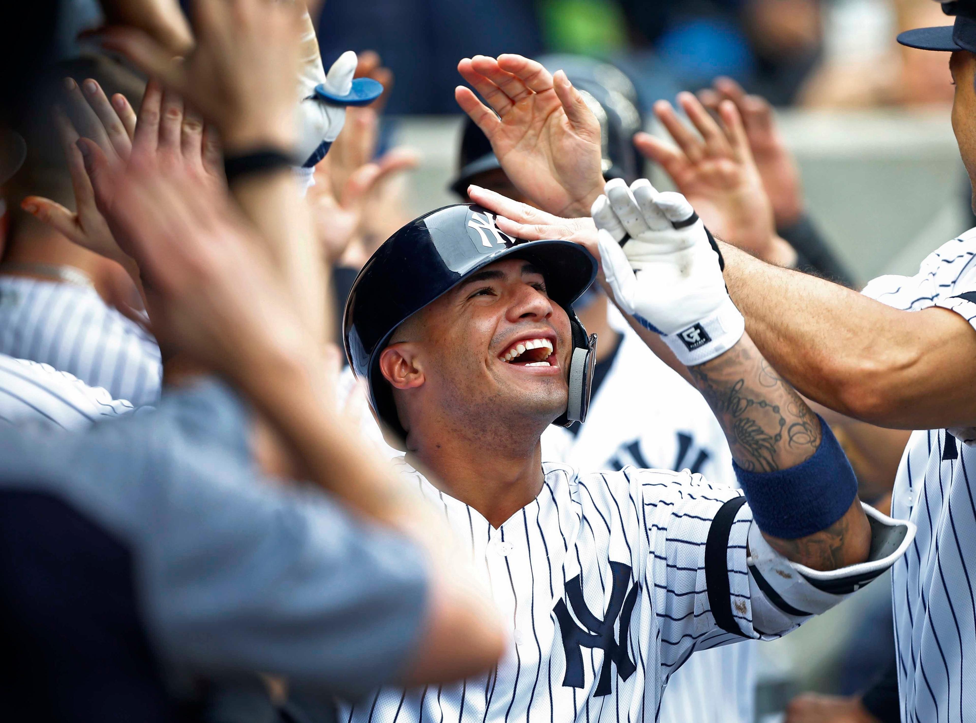 Jun 19, 2019; Bronx, NY, USA; New York Yankees second baseman Gleyber Torres (25) celebrates in the dugout after hitting a grand slam against the Tampa Bay Rays in the seventh inning at Yankee Stadium. Mandatory Credit: Noah K. Murray-USA TODAY Sports / Noah K. Murray