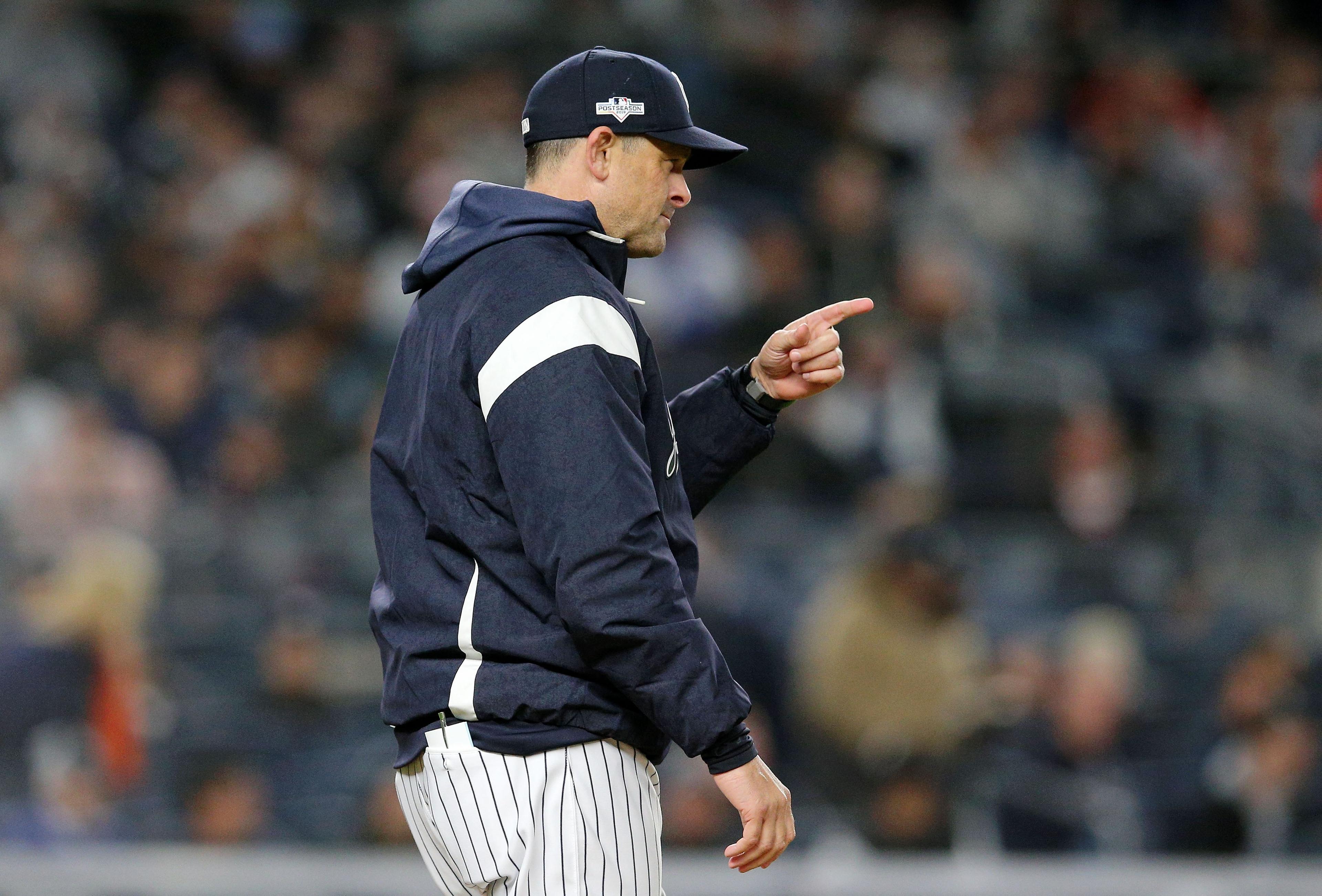 Oct 18, 2019; Bronx, NY, USA; New York Yankees manager Aaron Boone (17) signals for a pitching change against the Houston Astros during the seventh inning of game five of the 2019 ALCS playoff baseball series at Yankee Stadium. Mandatory Credit: Brad Penner-USA TODAY Sports