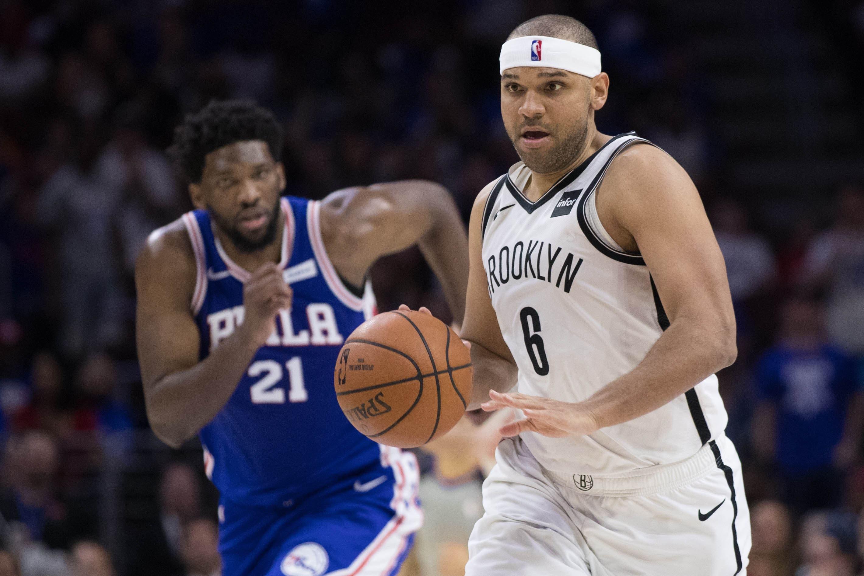 Brooklyn Nets forward Jared Dudley dribbles past Philadelphia 76ers center Joel Embiid during the fourth quarter in Game 1 of the first round of the 2019 NBA playoffs at Wells Fargo Center. / Bill Streicher/USA TODAY Sports