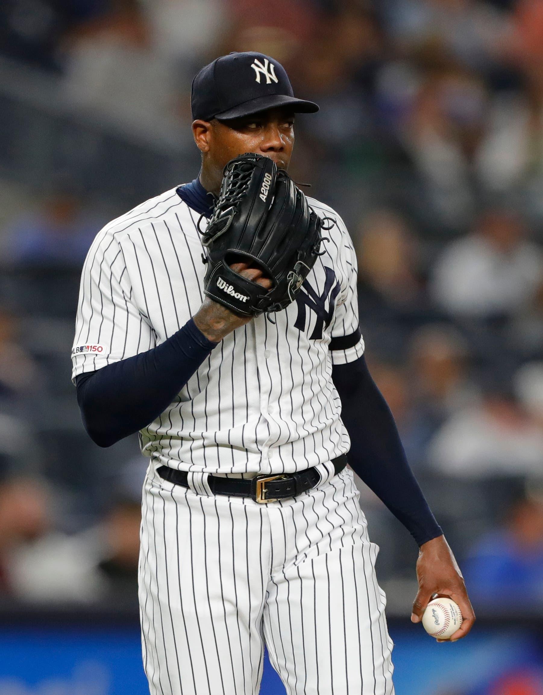 Jul 15, 2019; Bronx, NY, USA; New York Yankees relief pitcher Aroldis Chapman (54) pauses before pitching in the ninth inning against the Tampa Bay Rays at Yankee Stadium. Mandatory Credit: Noah K. Murray-USA TODAY Sports / Noah K. Murray