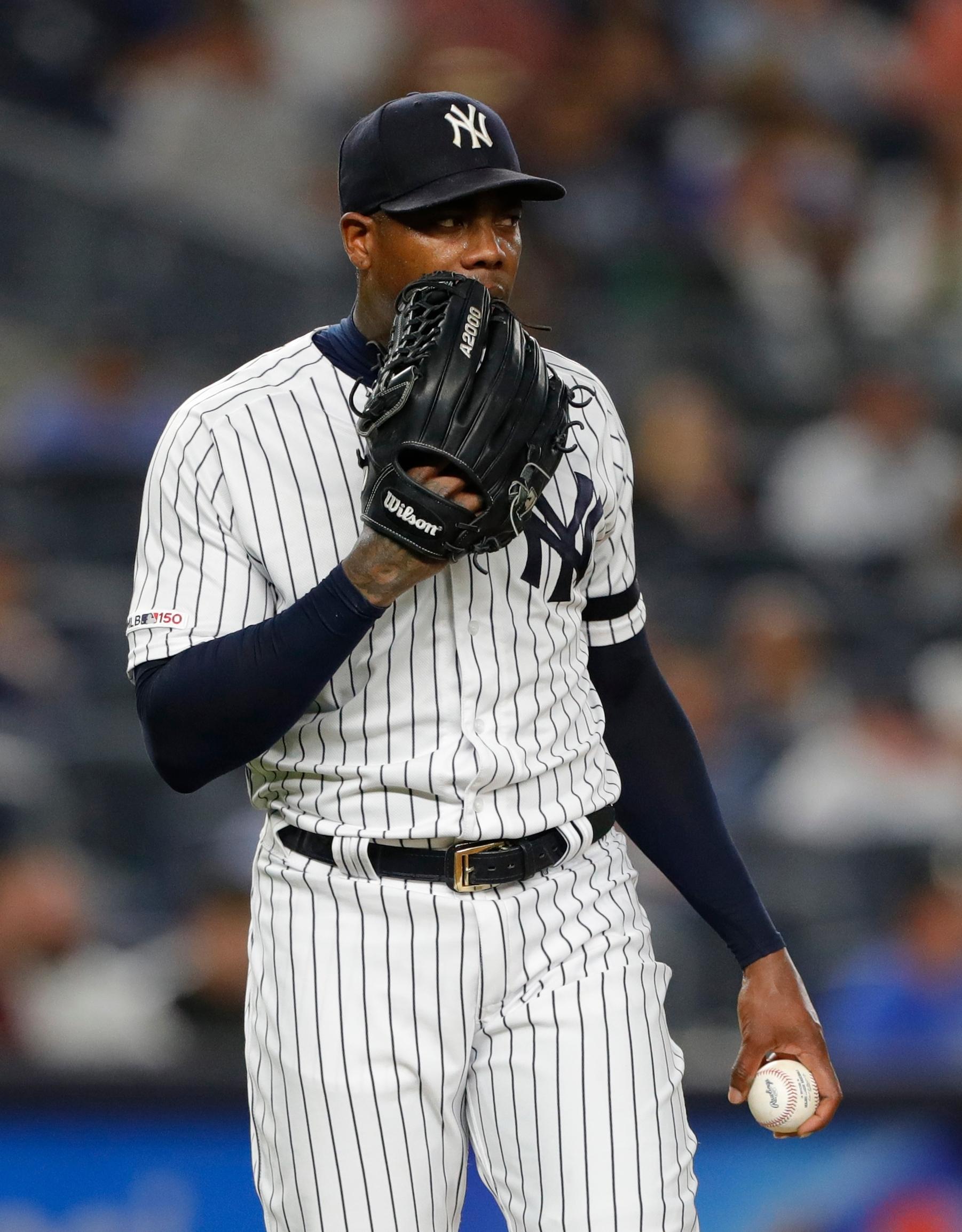 Jul 15, 2019; Bronx, NY, USA; New York Yankees relief pitcher Aroldis Chapman (54) pauses before pitching in the ninth inning against the Tampa Bay Rays at Yankee Stadium. Mandatory Credit: Noah K. Murray-USA TODAY Sports