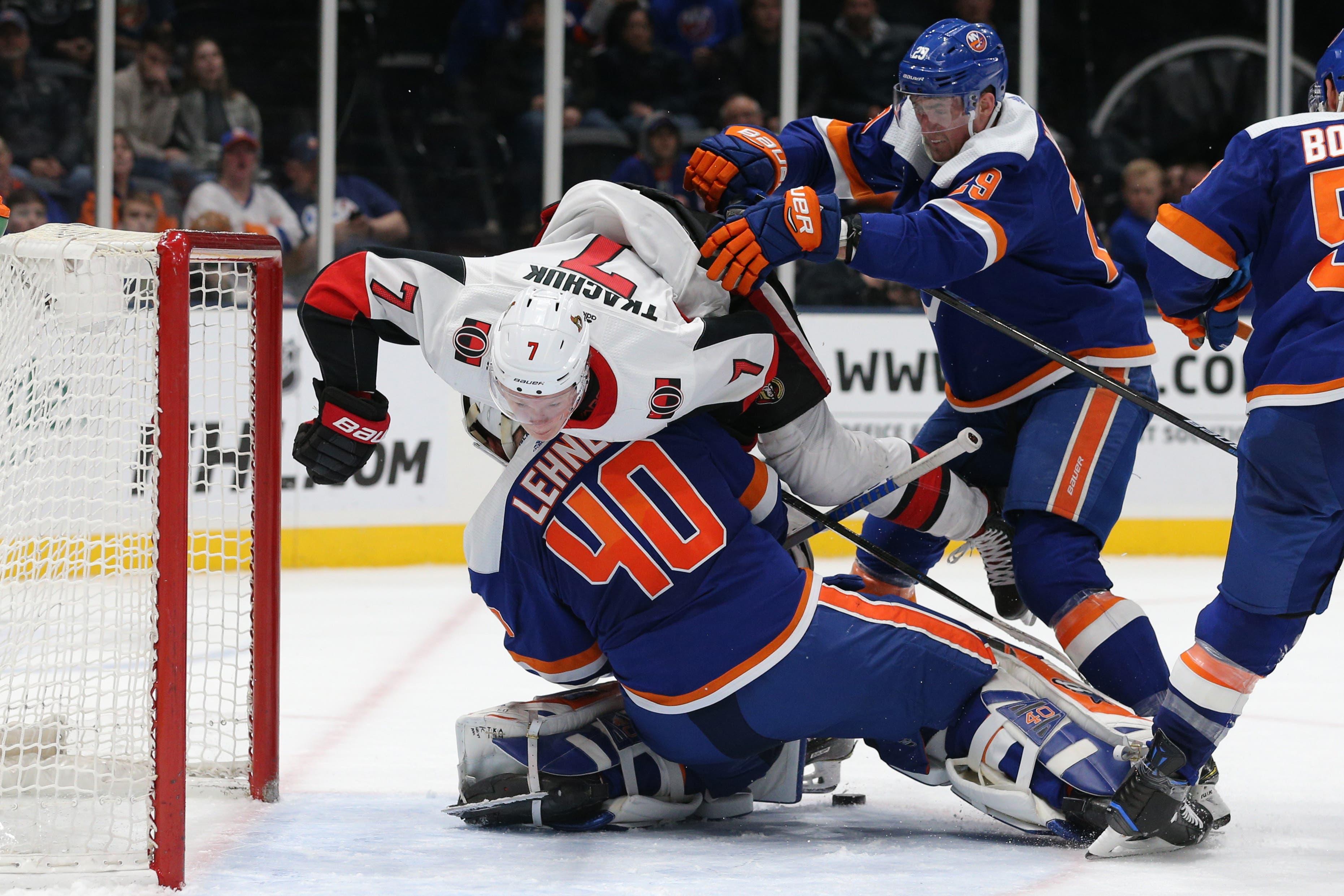 Mar 5, 2019; Uniondale, NY, USA; Ottawa Senators left wing Brady Tkachuk (7) is pushed over New York Islanders goalie Robin Lehner (40) by New York Islanders center Brock Nelson (29) during the third period at Nassau Veterans Memorial Coliseum. Mandatory Credit: Brad Penner-USA TODAY Sports / Brad Penner