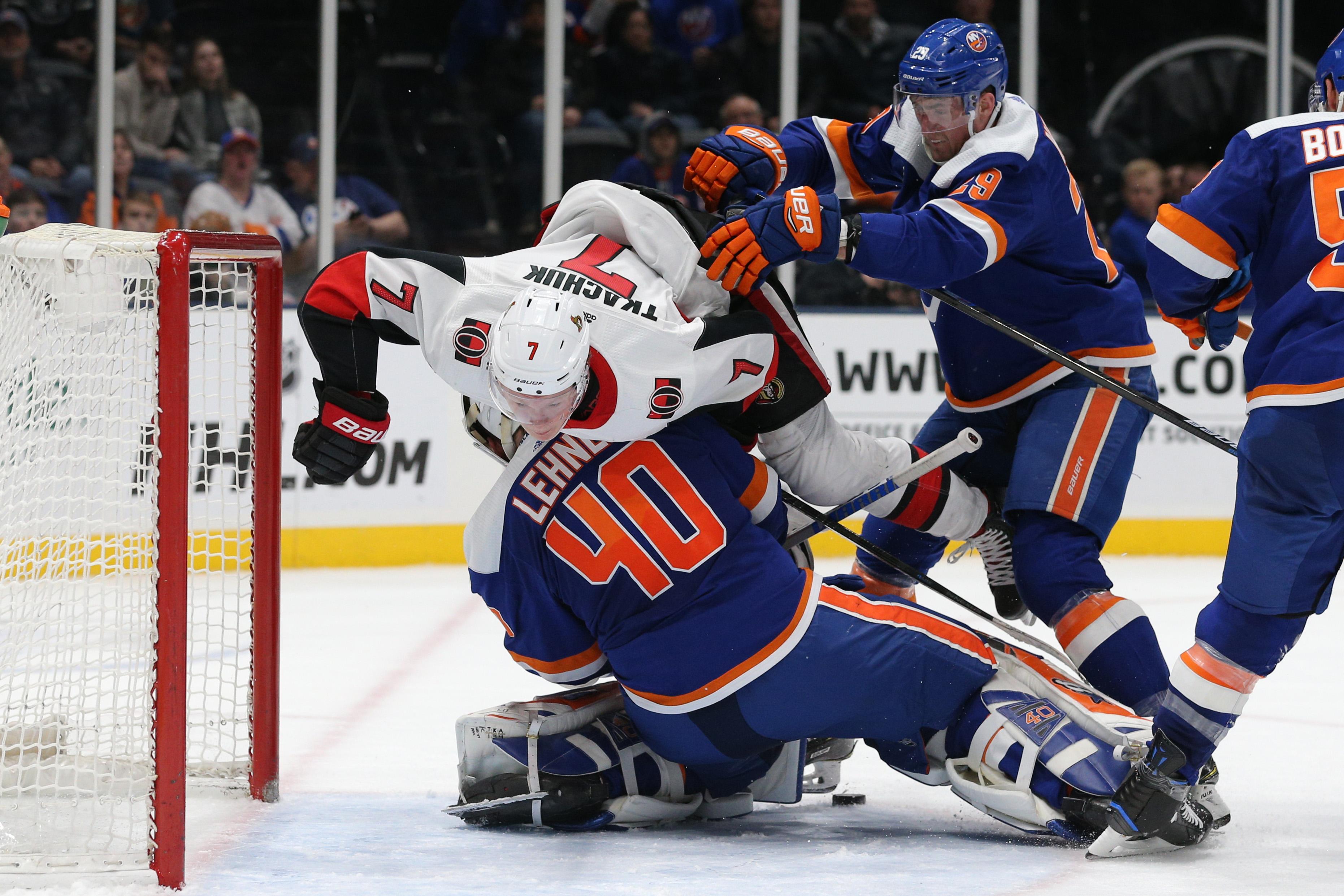 Mar 5, 2019; Uniondale, NY, USA; Ottawa Senators left wing Brady Tkachuk (7) is pushed over New York Islanders goalie Robin Lehner (40) by New York Islanders center Brock Nelson (29) during the third period at Nassau Veterans Memorial Coliseum. Mandatory Credit: Brad Penner-USA TODAY Sports