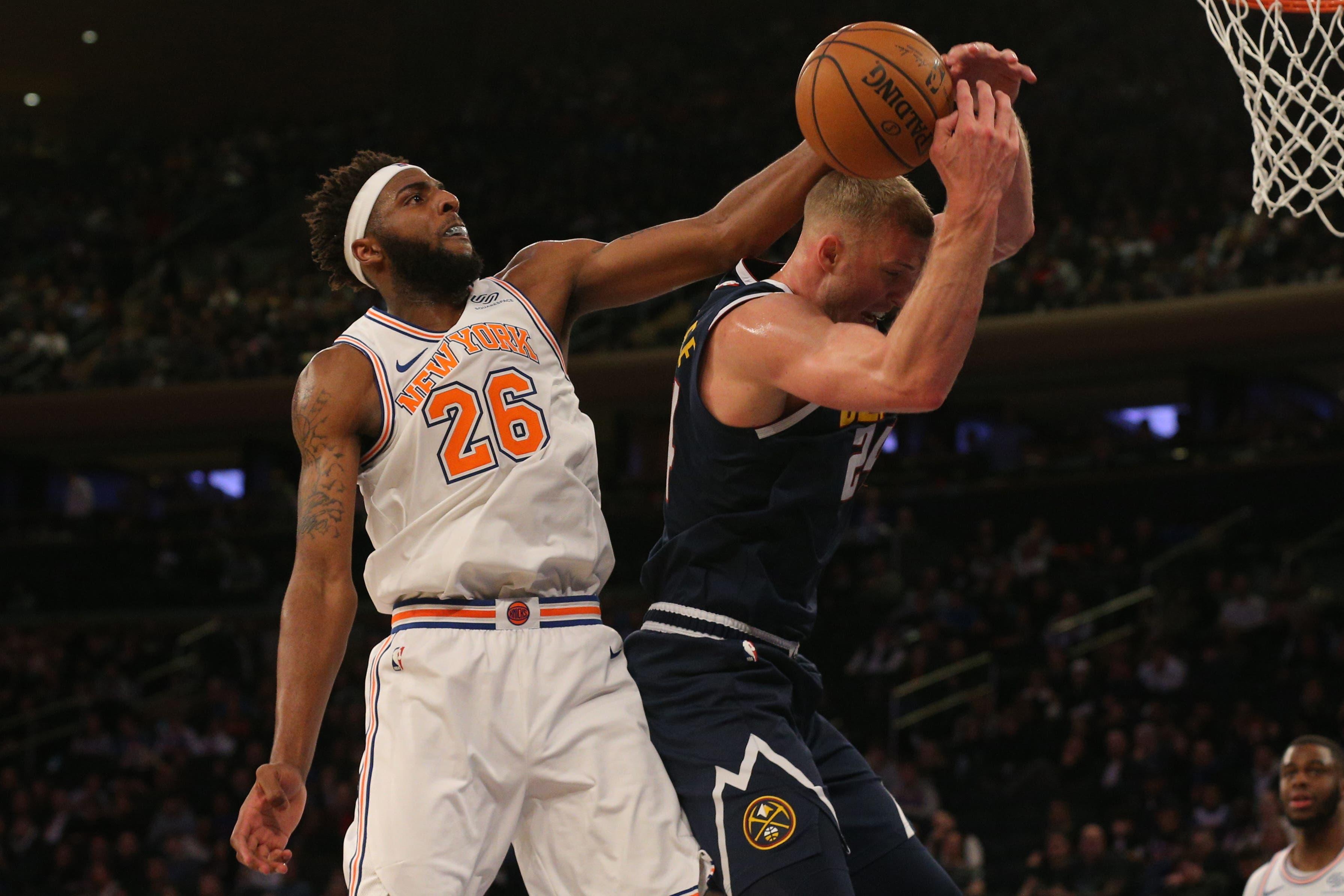 Mar 22, 2019; New York, NY, USA; New York Knicks center Mitchell Robinson (26) and Denver Nuggets power forward Mason Plumlee (24) fight for a rebound during the fourth quarter at Madison Square Garden. Mandatory Credit: Brad Penner-USA TODAY Sports / Brad Penner