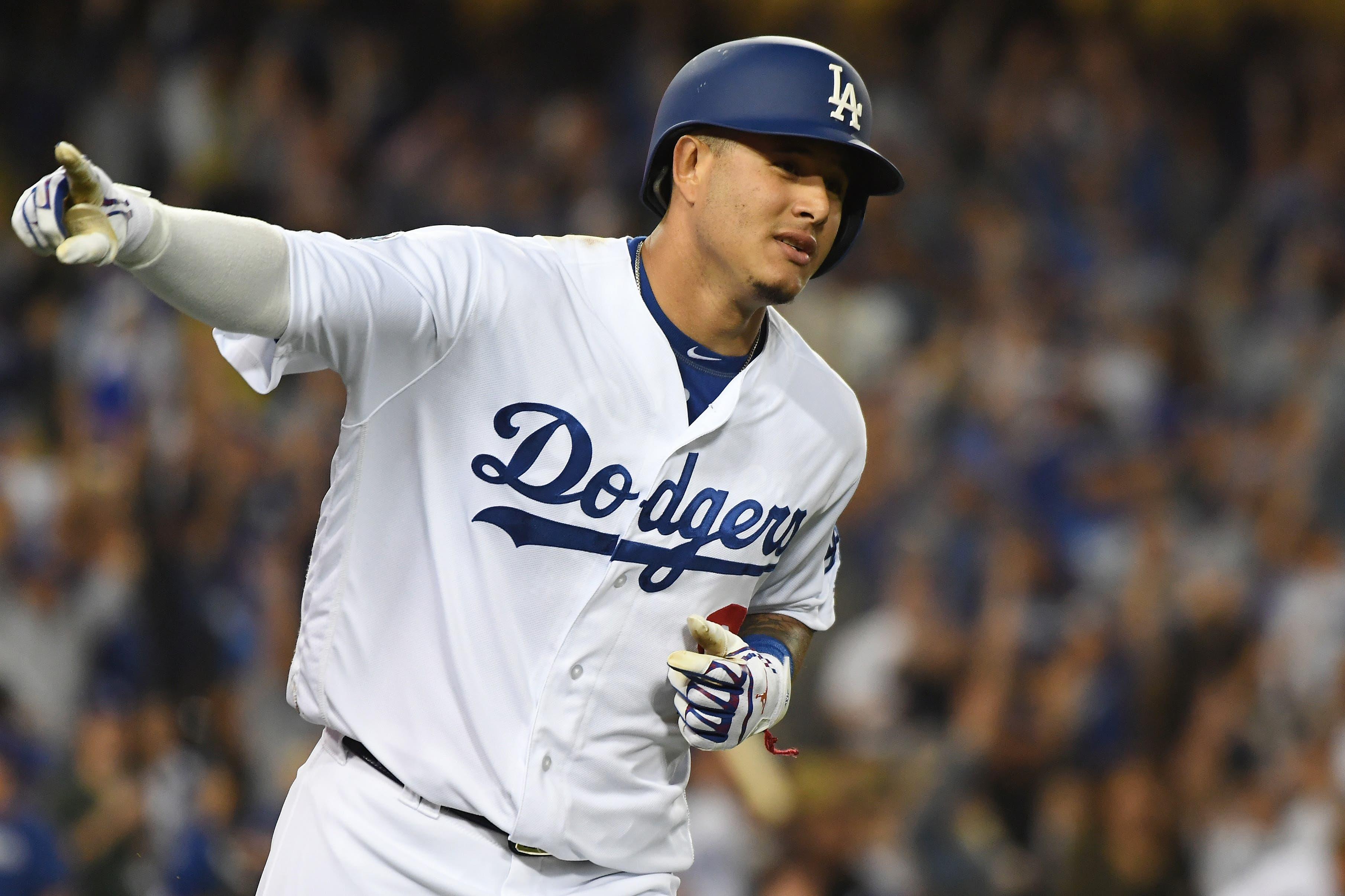 Los Angeles Dodgers shortstop Manny Machado celebrates after hitting a home run during the first inning against the against the Atlanta Braves in Game 2 of the 2018 NLDS at Dodger Stadium. / Richard Mackson-USA TODAY Sports