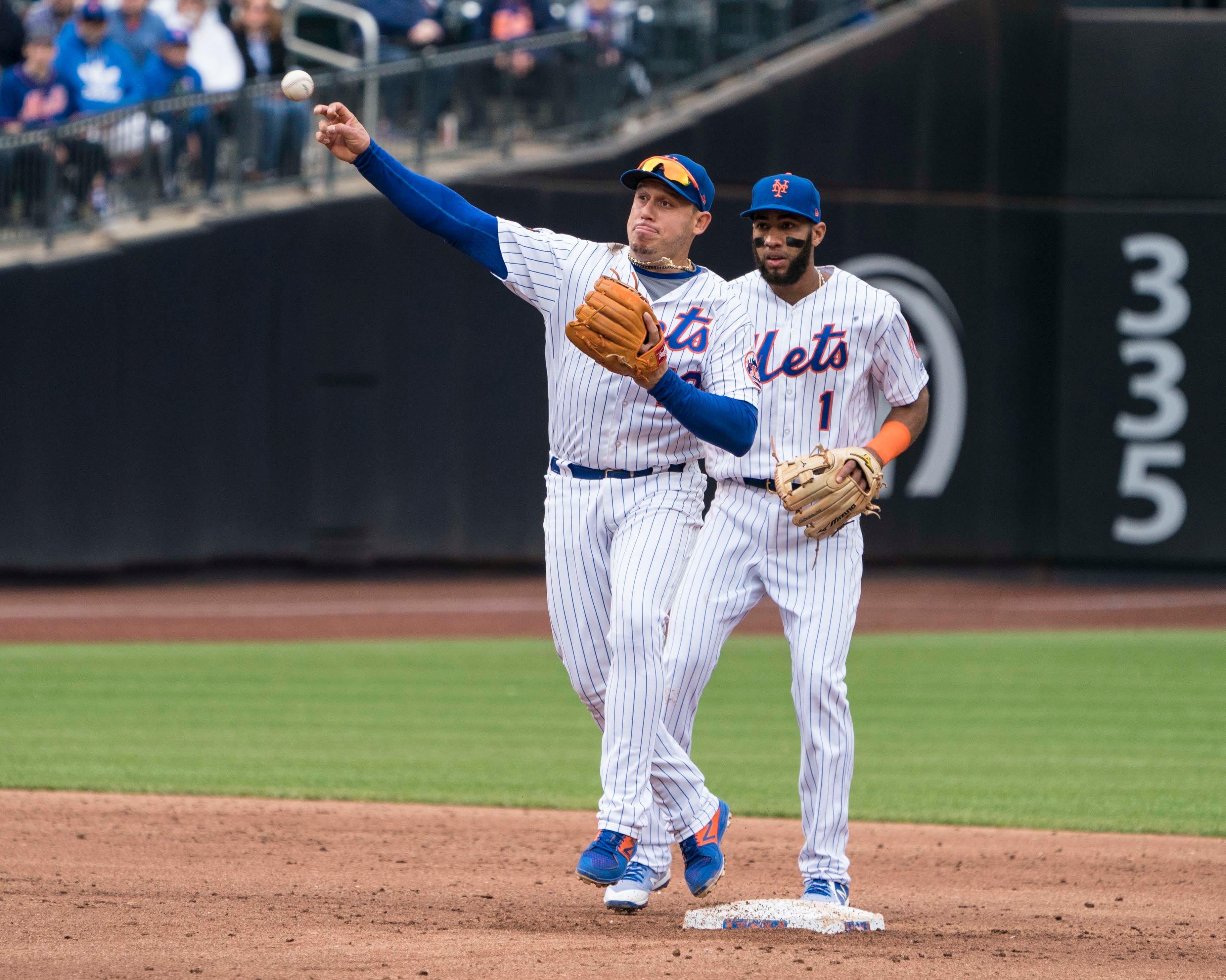 May 6, 2018; New York City, NY, USA; New York Mets second baseman Asdrubal Cabrera (13) turns a double play against the Colorado Rockies during the third inning of the game at Citi Field. Mandatory Credit: Gregory J. Fisher-USA TODAY Sports / Gregory Fisher