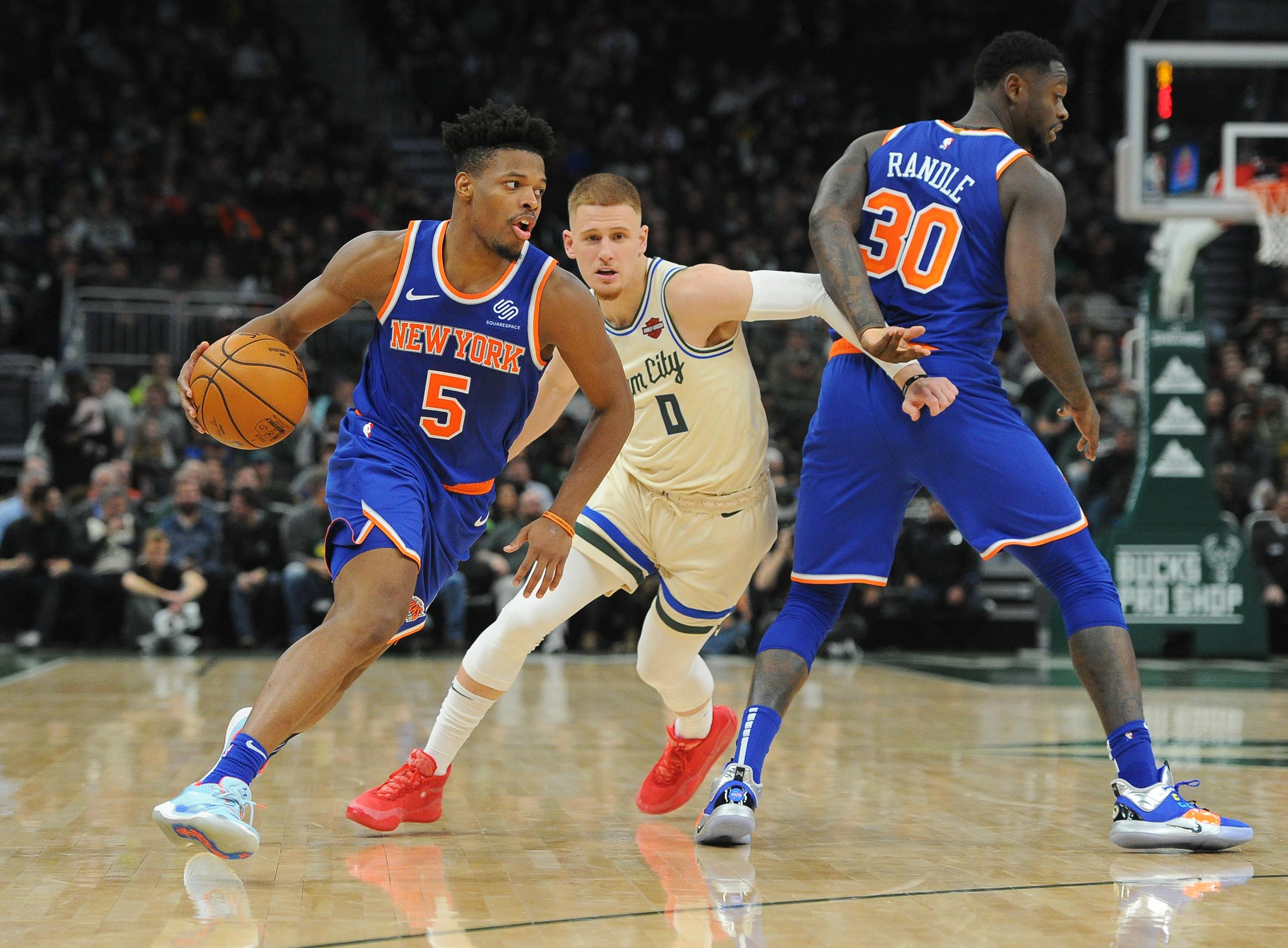 Dec 2, 2019; Milwaukee, WI, USA; New York Knicks guard Dennis Smith Jr. (5) drives to the basket with a pick set by Knicks forward Julius Randle (30) against Milwaukee Bucks guard Donte DiVincenzo (0) in the third quarter at Fiserv Forum. Mandatory Credit: Michael McLoone-USA TODAY Sports 