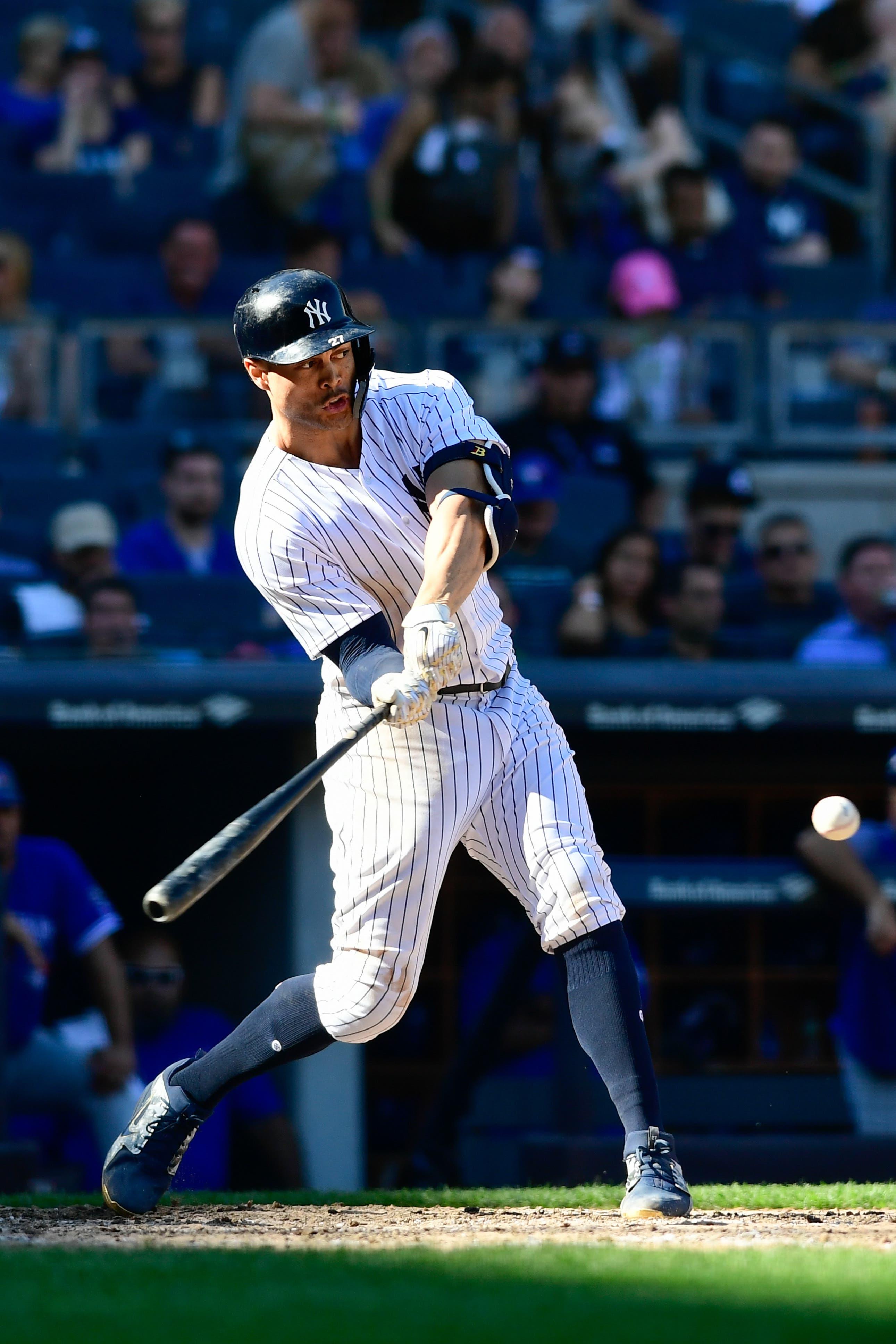 New York Yankees designated hitter Giancarlo Stanton hits a single to left field during the eighth inning against Toronto Blue Jays at Yankee Stadium. / Catalina Fragoso/USA TODAY Sports