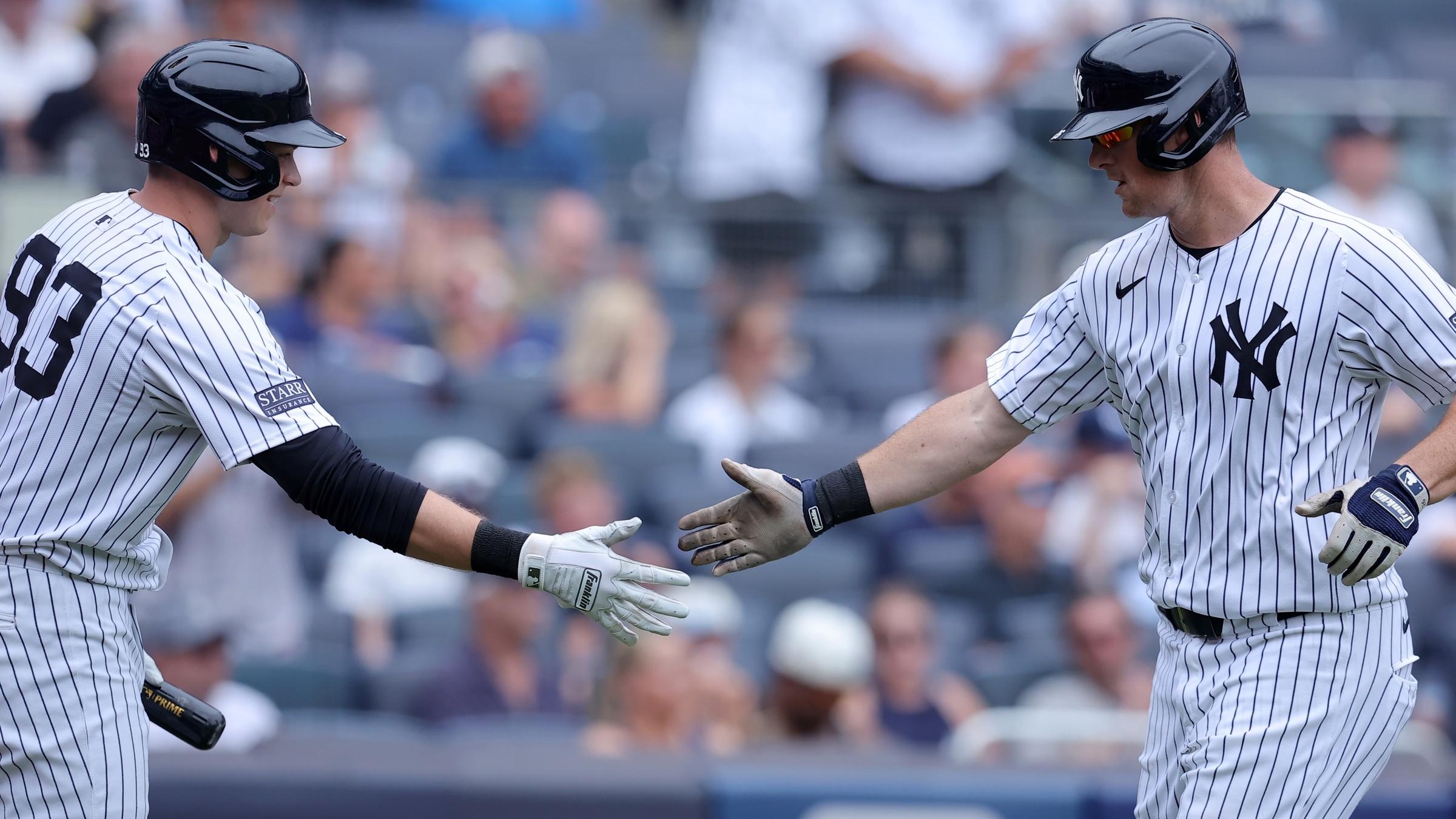 New York Yankees third baseman DJ LeMahieu (26) celebrates his solo home run against the Tampa Bay Rays with first baseman Ben Rice (93) during the fifth inning at Yankee Stadium.