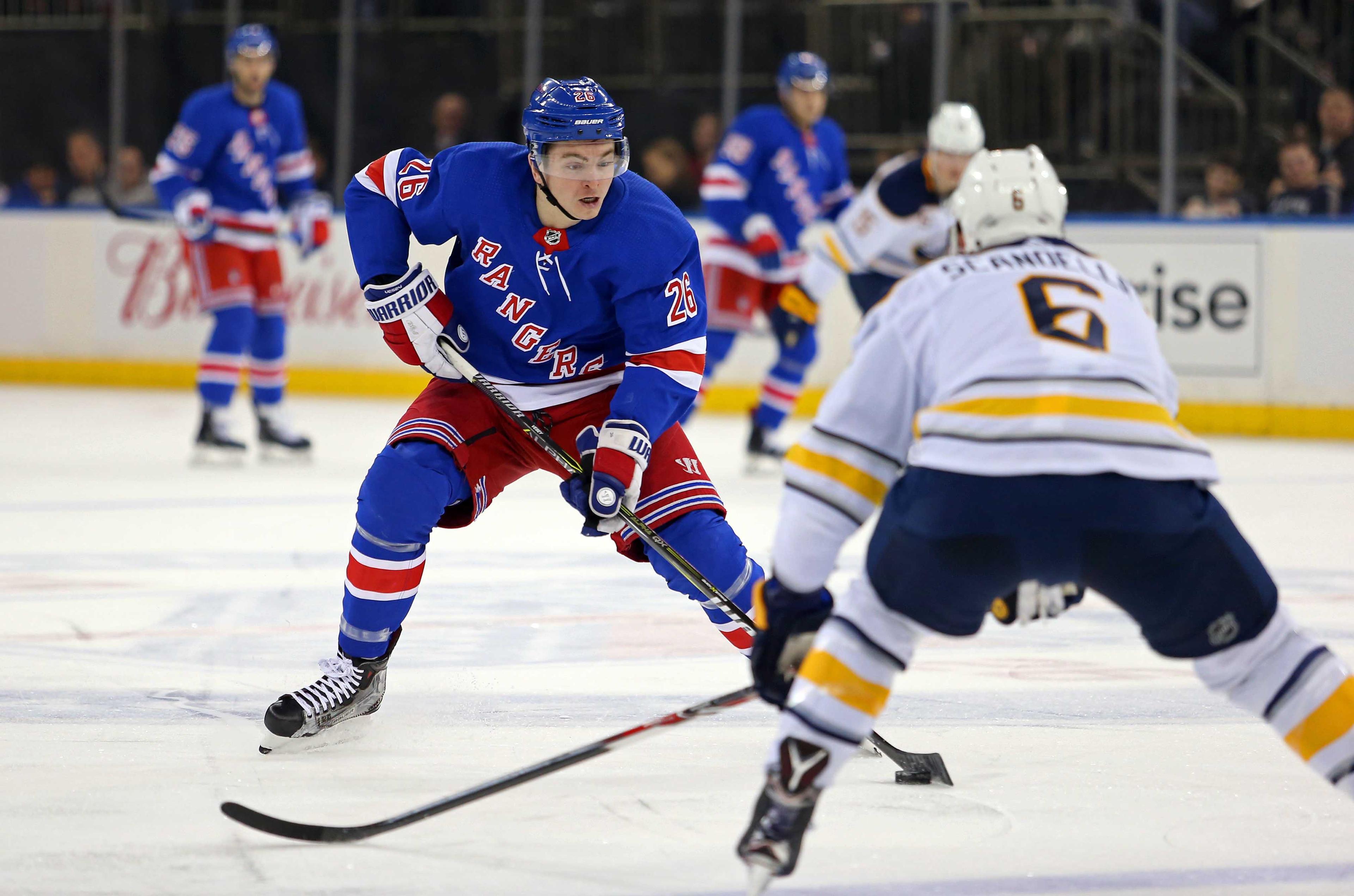 Mar 24, 2018; New York, NY, USA; New York Rangers left wing Jimmy Vesey (26) skates with the puck in front of Buffalo Sabres defenseman Marco Scandella (6) during the second period at Madison Square Garden. Mandatory Credit: Danny Wild-USA TODAY Sports / Danny Wild