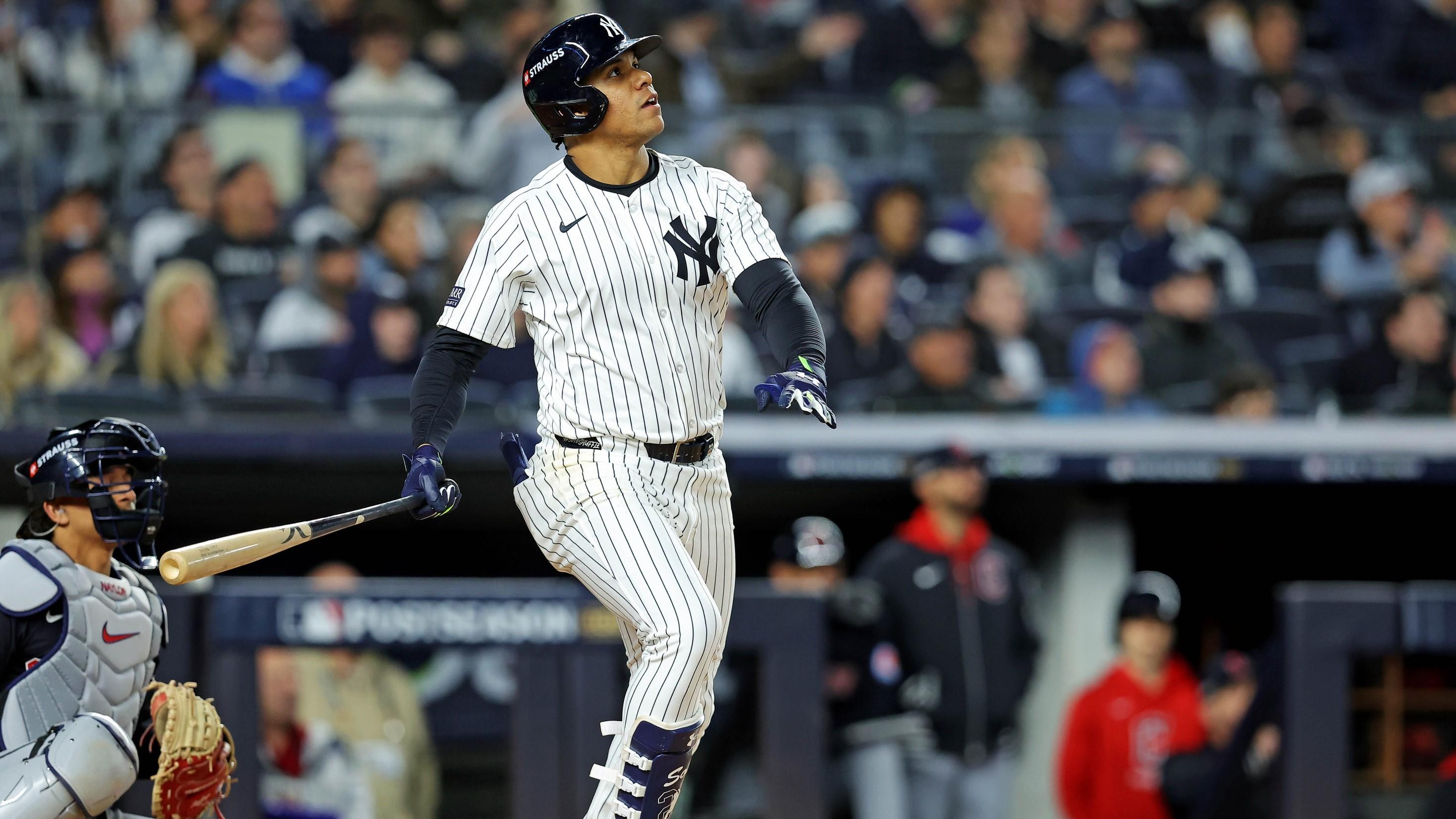 Oct 14, 2024; Bronx, New York, USA; New York Yankees outfielder Juan Soto (22) hits a solo home run during the third inning against the Cleveland Guardians in game one of the ALCS for the 2024 MLB Playoffs at Yankee Stadium.