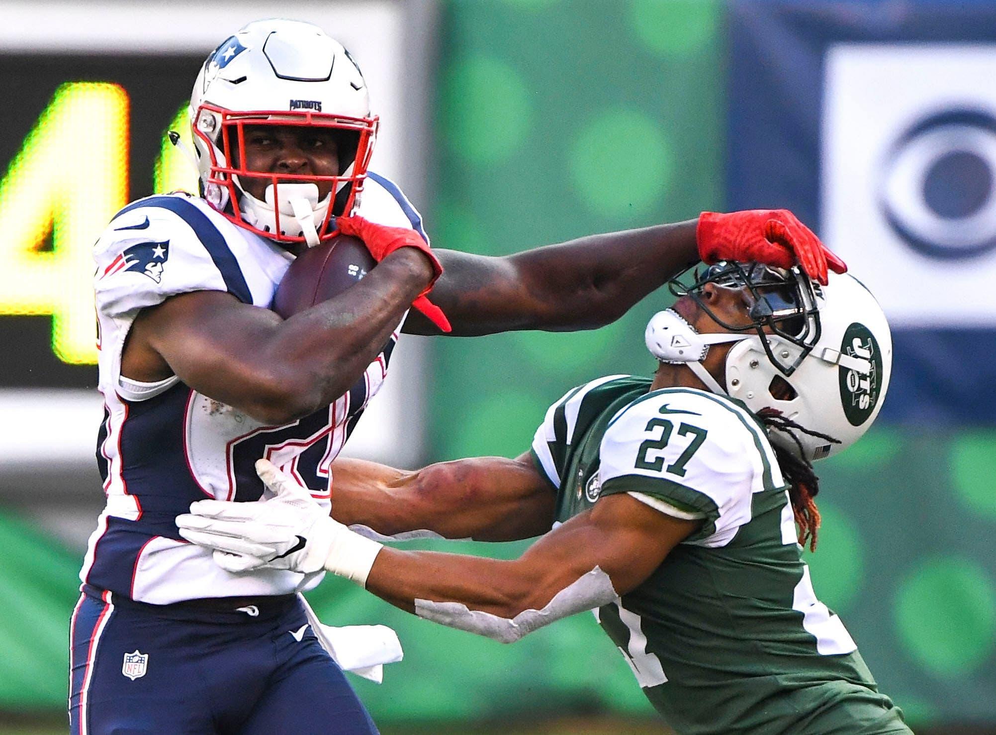 Nov 25, 2018; East Rutherford, NJ, USA; New England Patriots running back Sony Michel (26) gets stopped by New York Jets cornerback Darryl Roberts (27) after a 1st down run in the 3rd quarter at MetLife Stadium. Mandatory Credit: Robert Deutsch-USA TODAY Sports / Robert Deutsch